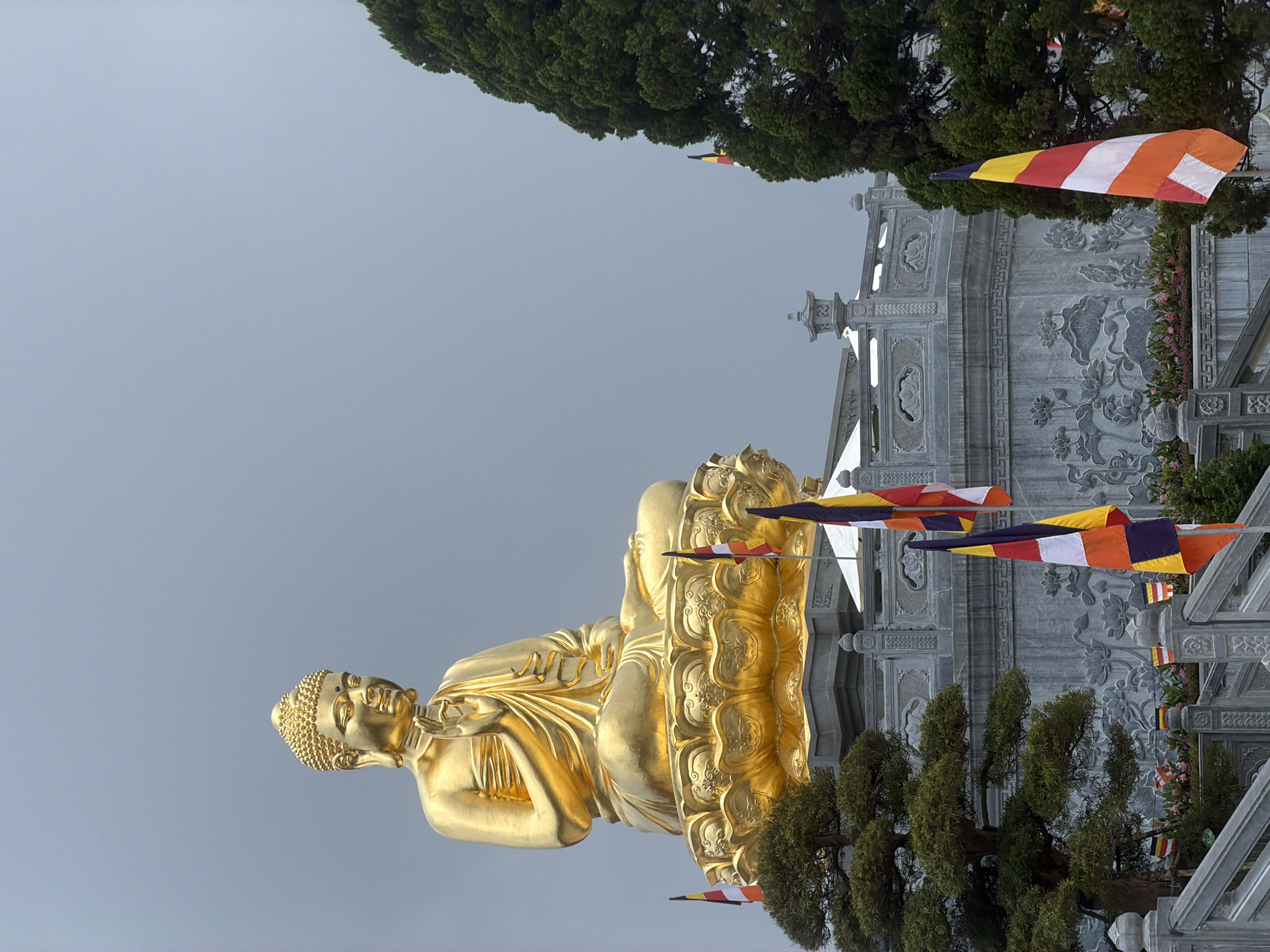 Golden Buddha statue photographed at Suoi Dau temple site