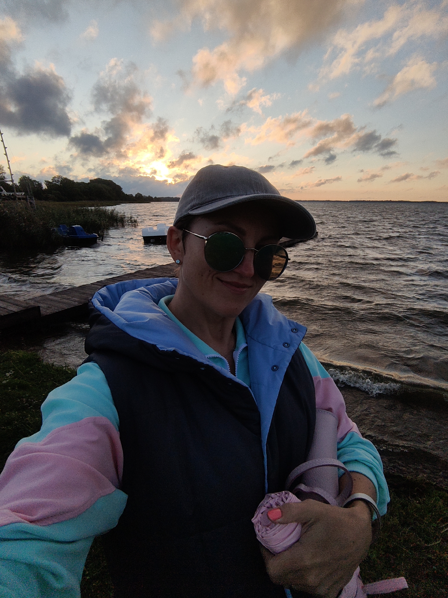 Sunset at a lakeside beach and dock in Myadzyel, Belarus