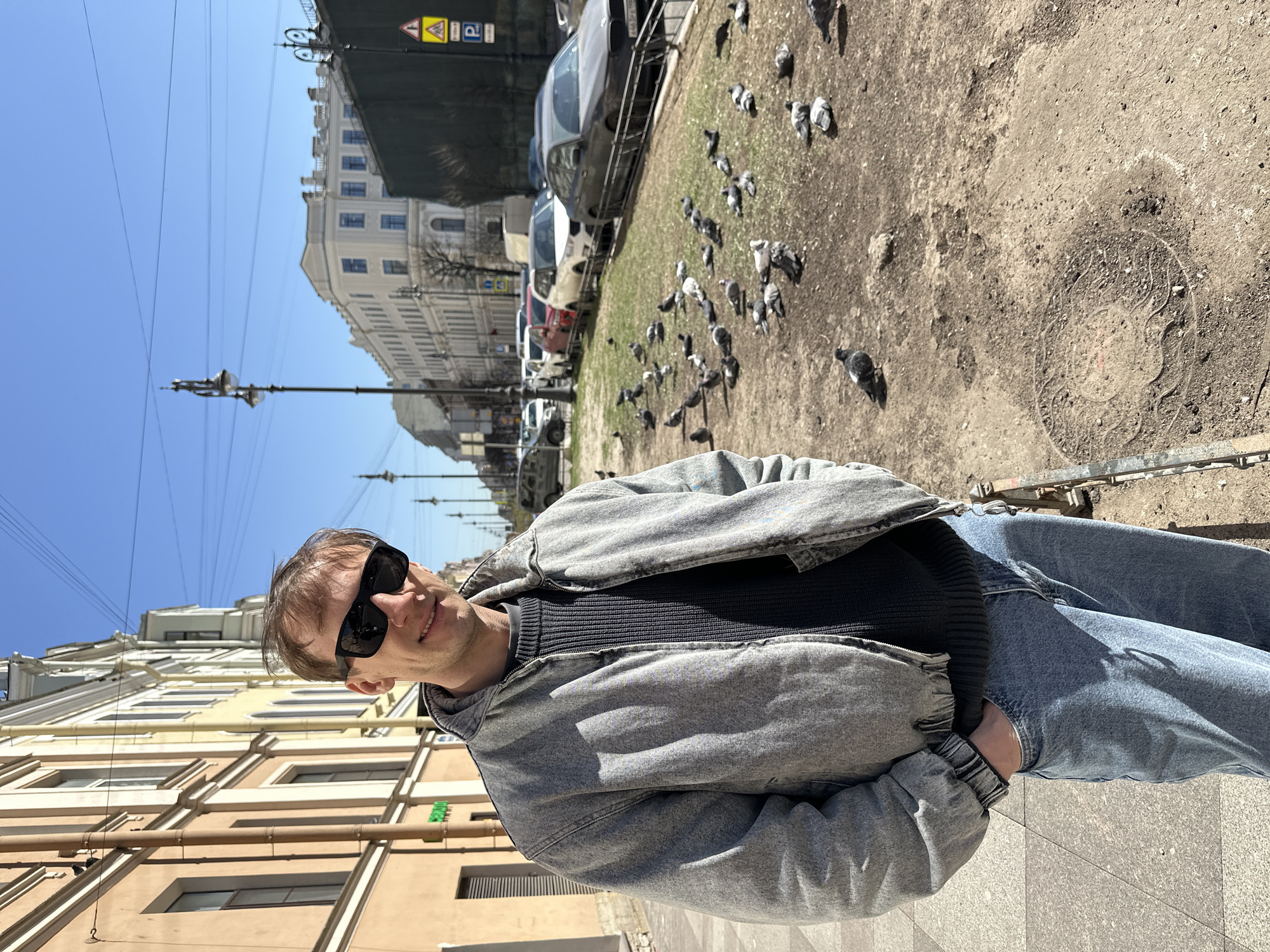 Man photographed near decaying building in sunny Saint Petersburg