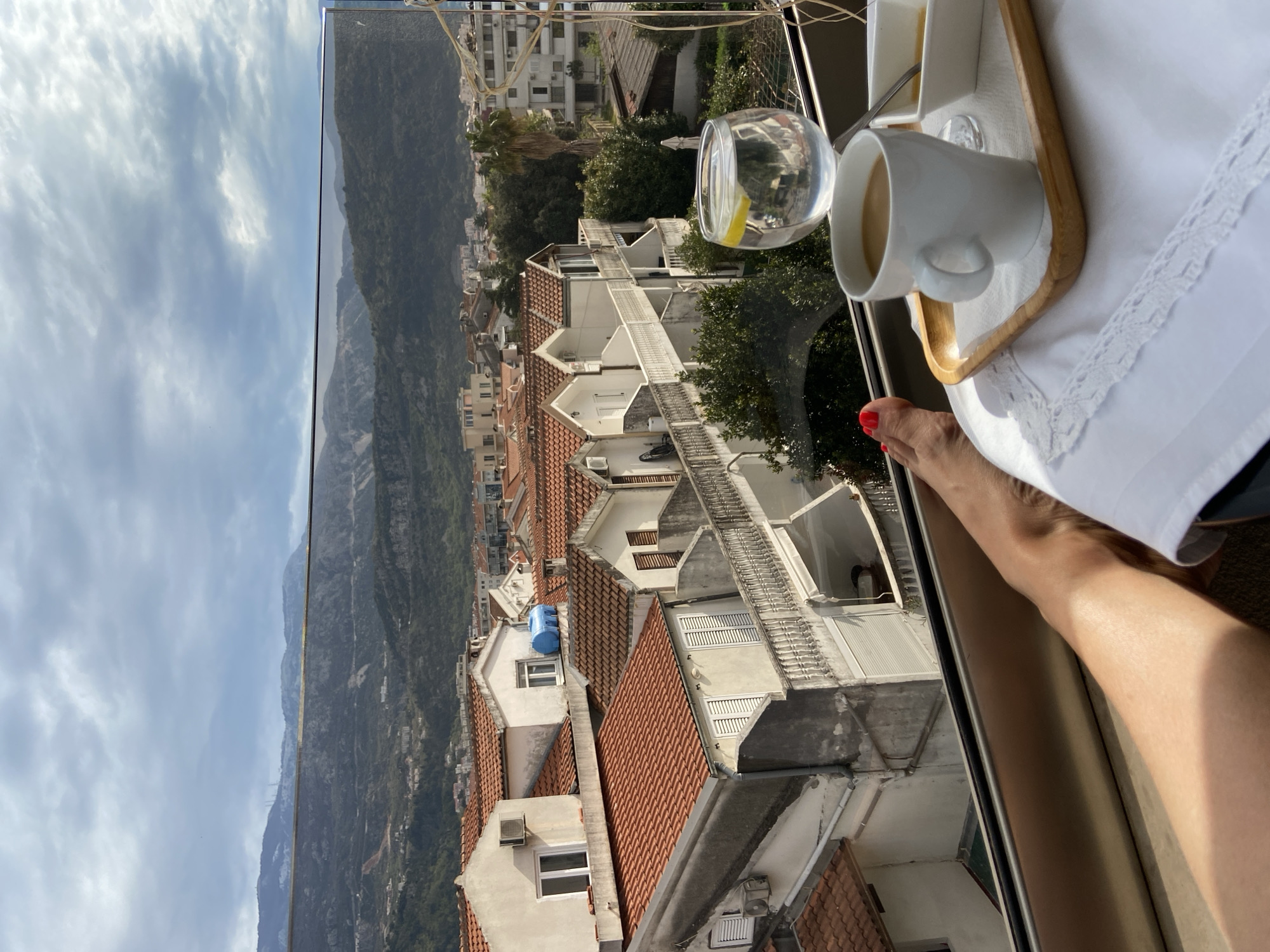 Morning breakfast documented overlooking Budva's Mediterranean coastline