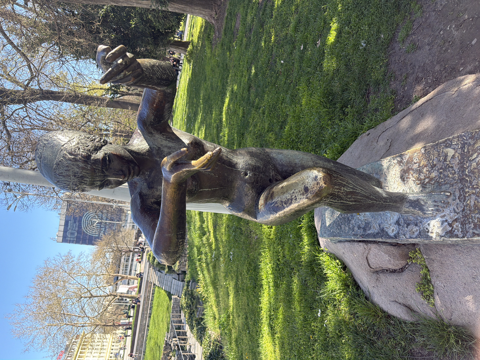 Person photographs park monument with smartphone