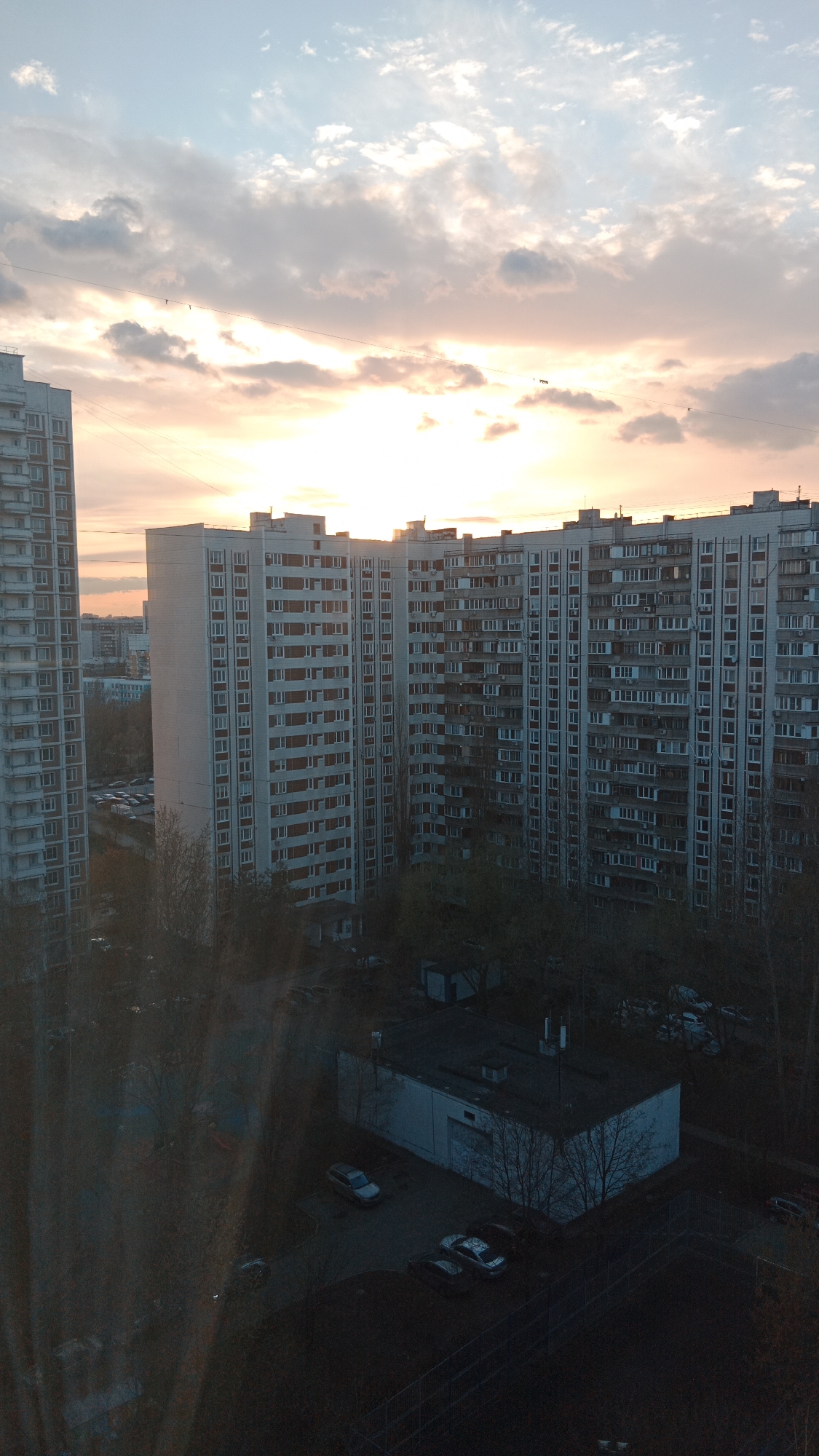 Moscow apartment buildings observed during peach sunset Monday evening