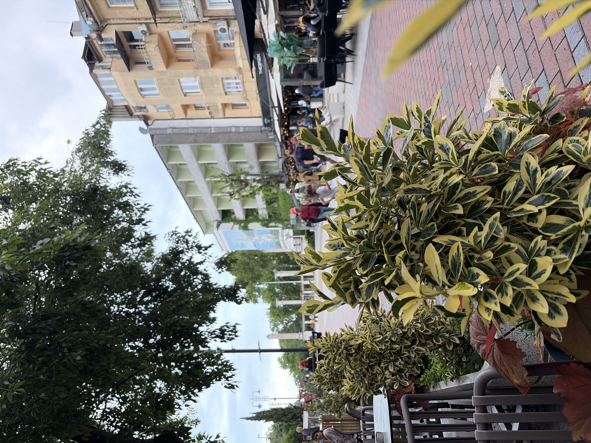 Morning street scene with café seating observed in Varna