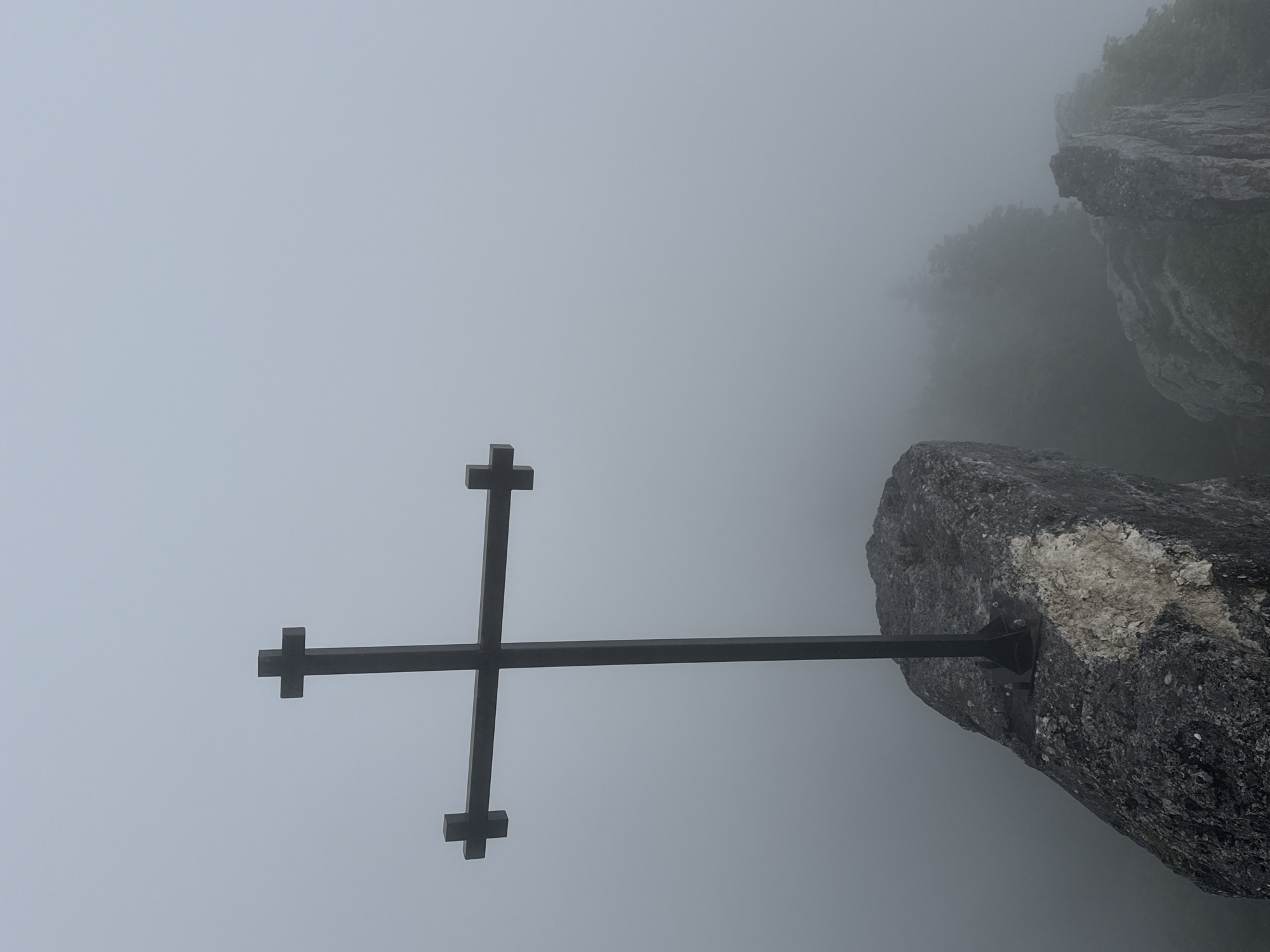 Foggy cross-marked rocky outcrop in Dzirovani, Georgia