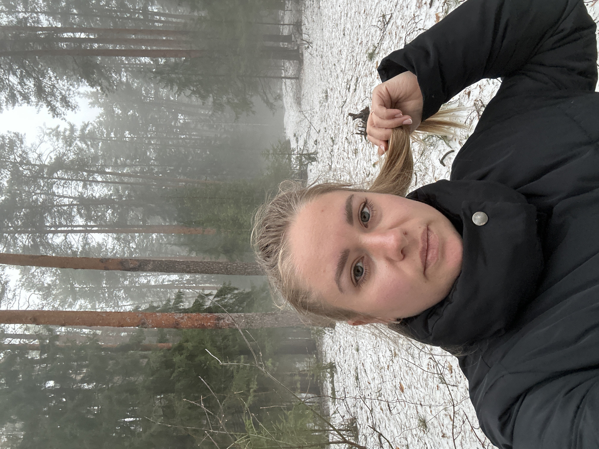 Woman takes winter selfies in foggy Russian forest