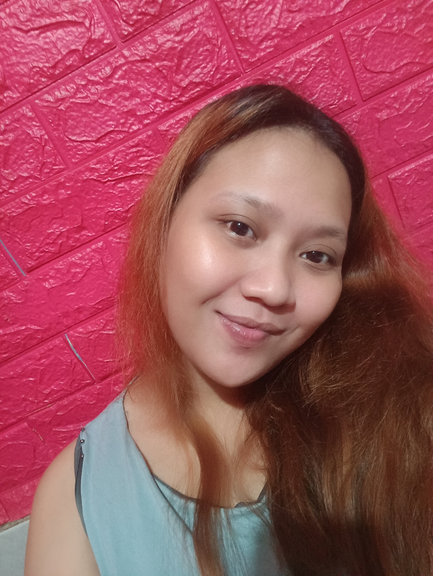 Indoor selfie session against a textured wall in Depok