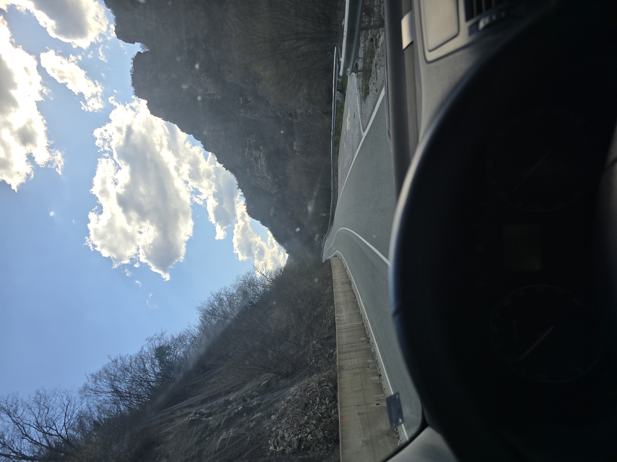Vehicle travels winding mountain road in Mihalkovo, Bulgaria