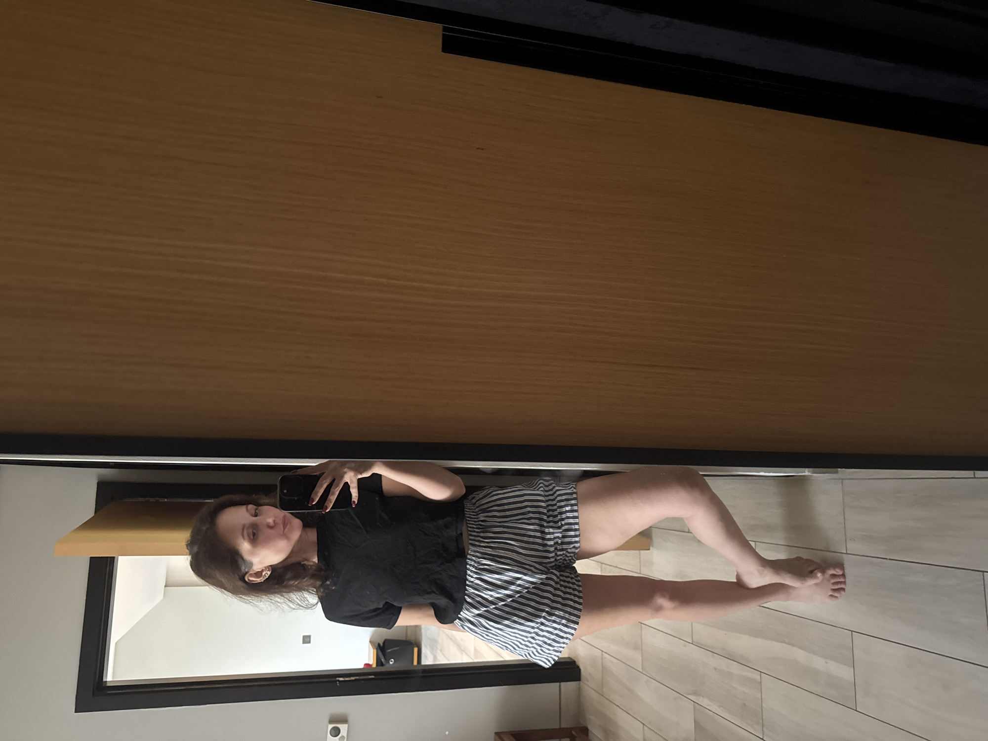 Woman takes mirror selfie in Dubai room
