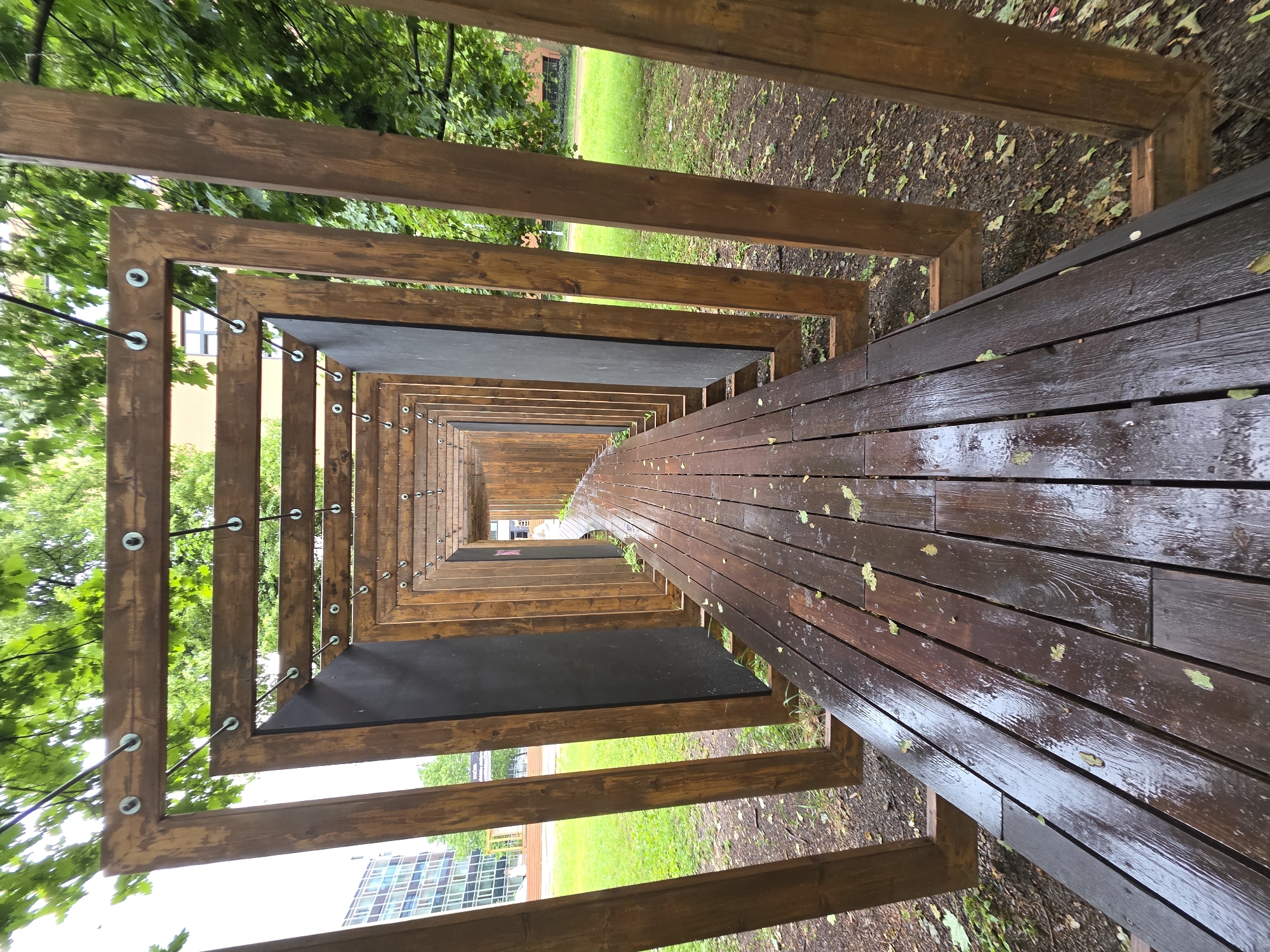 Wooden tunnel structure photographed from elevated perspective