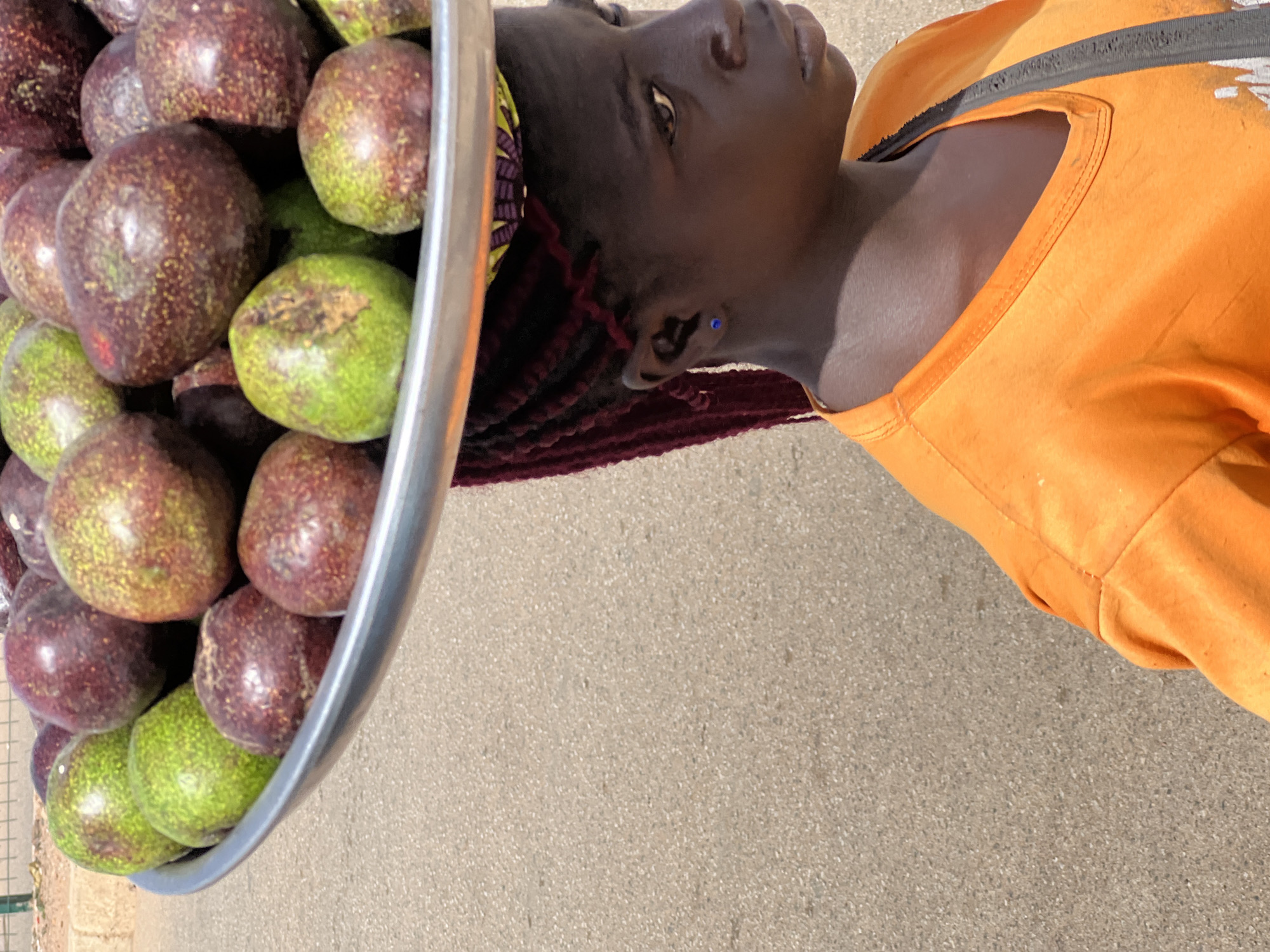 Woman in orange shirt photographed in Bukuru, Nigeria