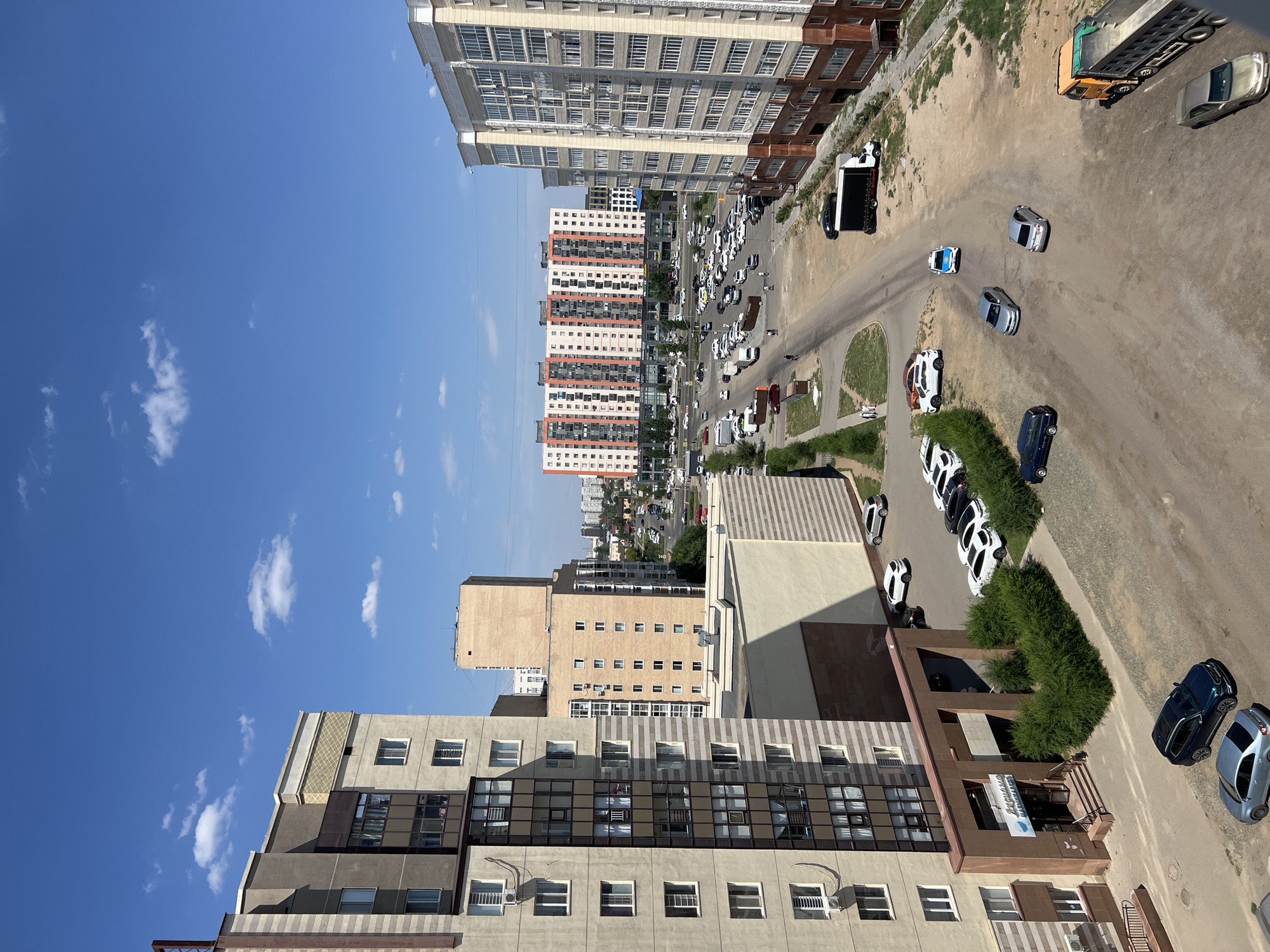 Modern apartment building photographed from multiple angles, sunny day