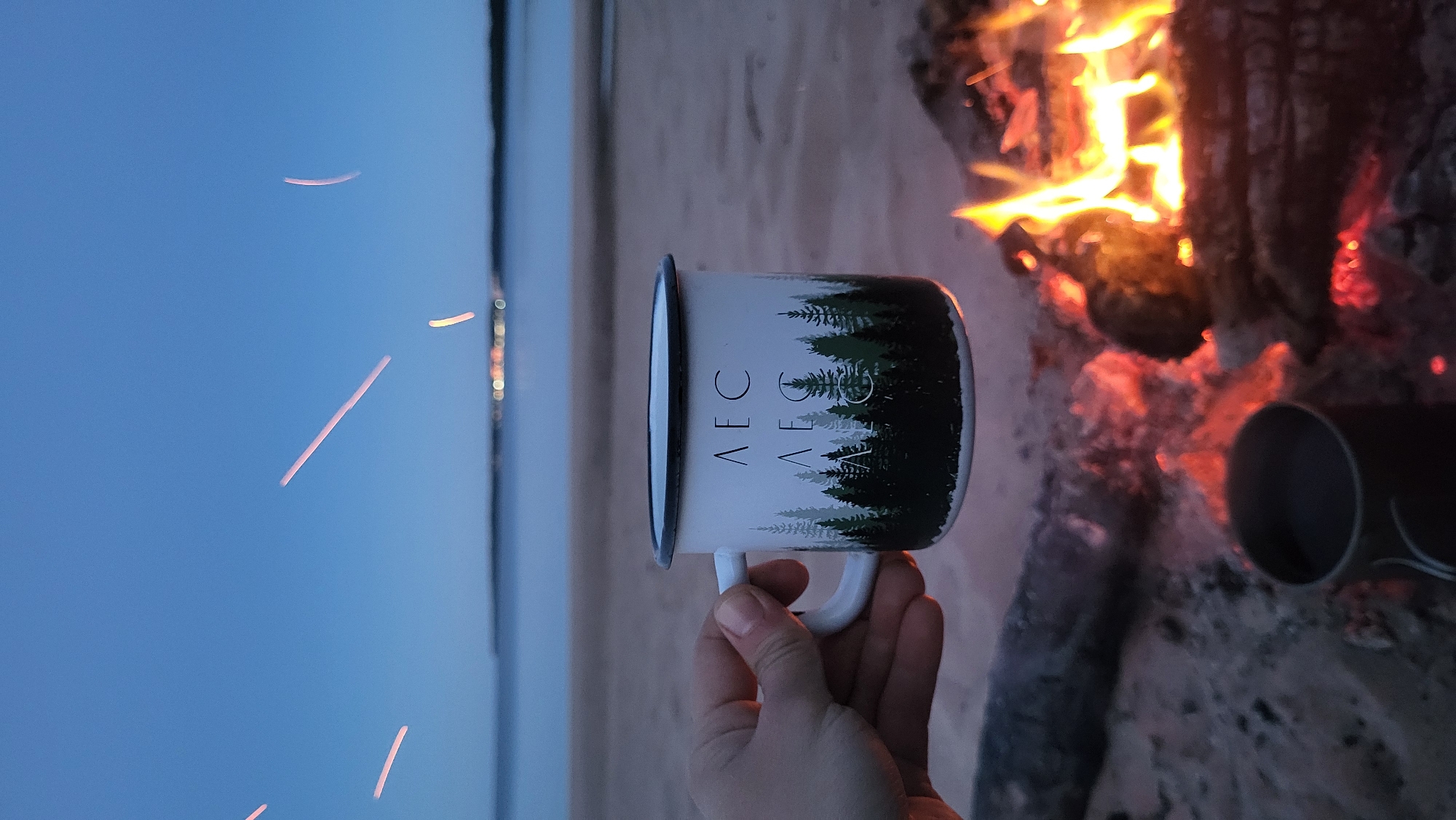 Campfire and forest mugs on a Russian beach at dusk