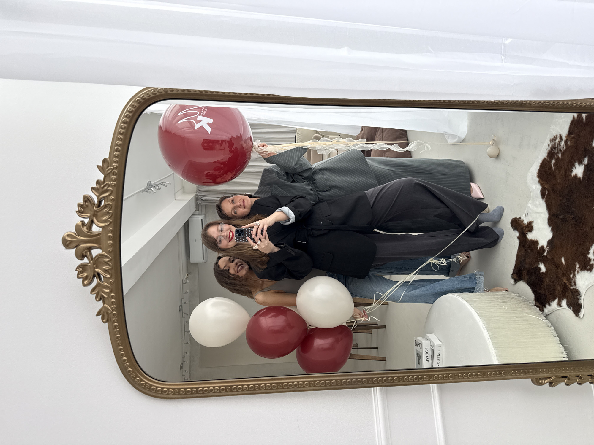 Women take selfie with balloons in ornate mirror, Izhevsk