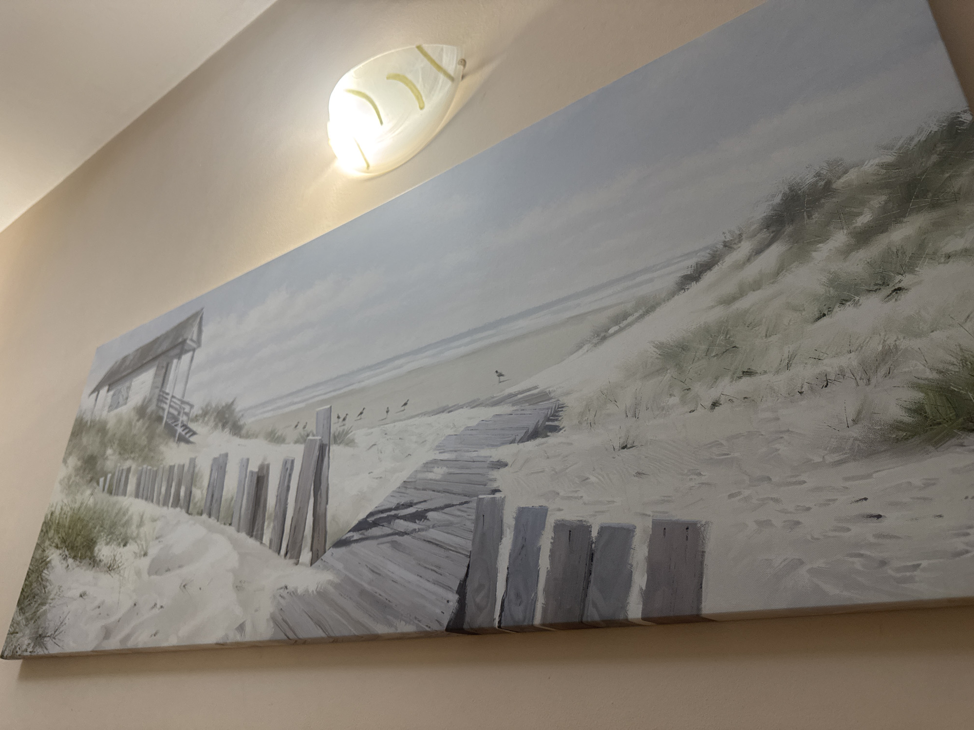 Coastal painting documented in gallery or private space