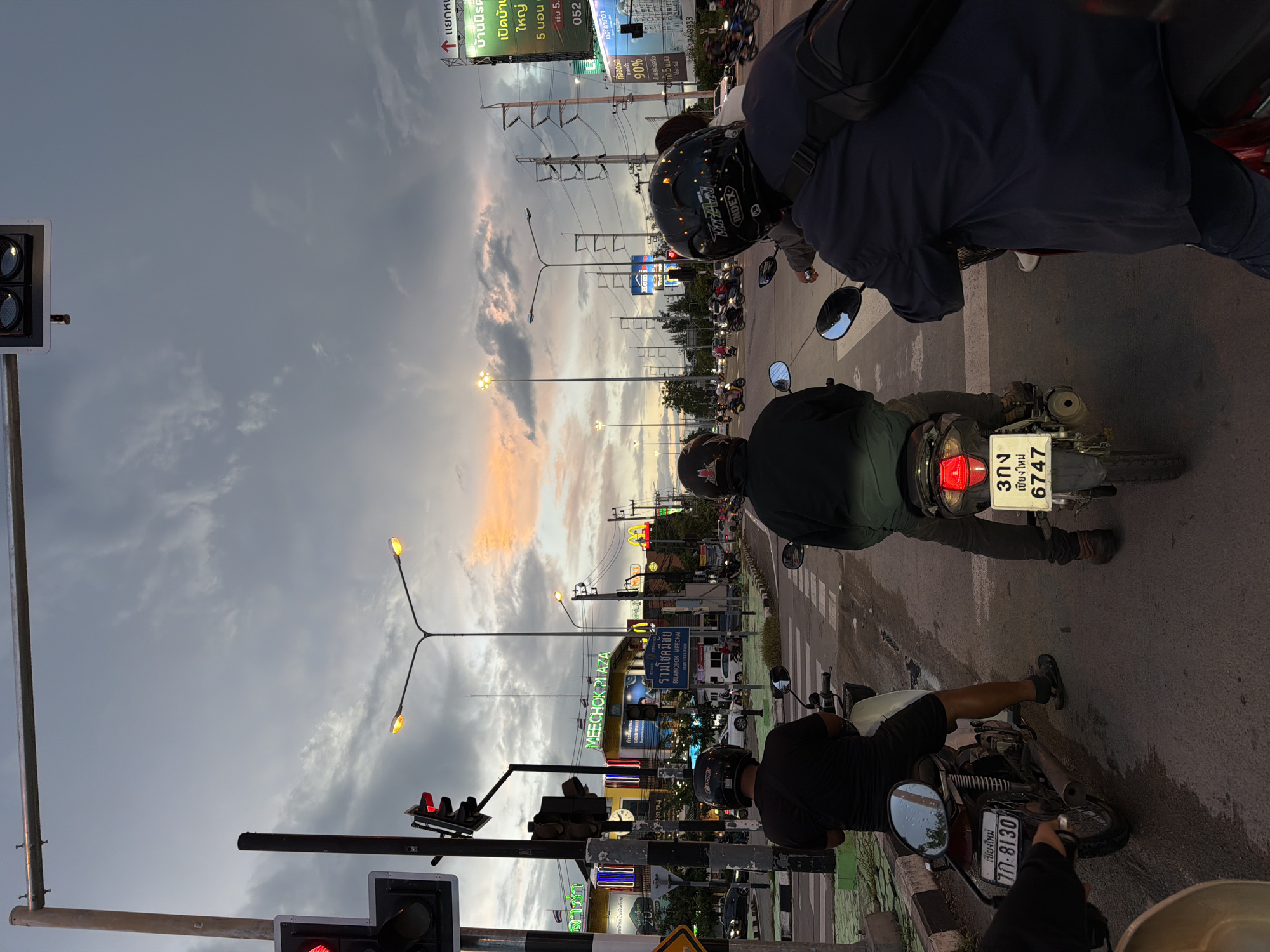 Dusk traffic at a Chang Phueak intersection, motorcycles at the light