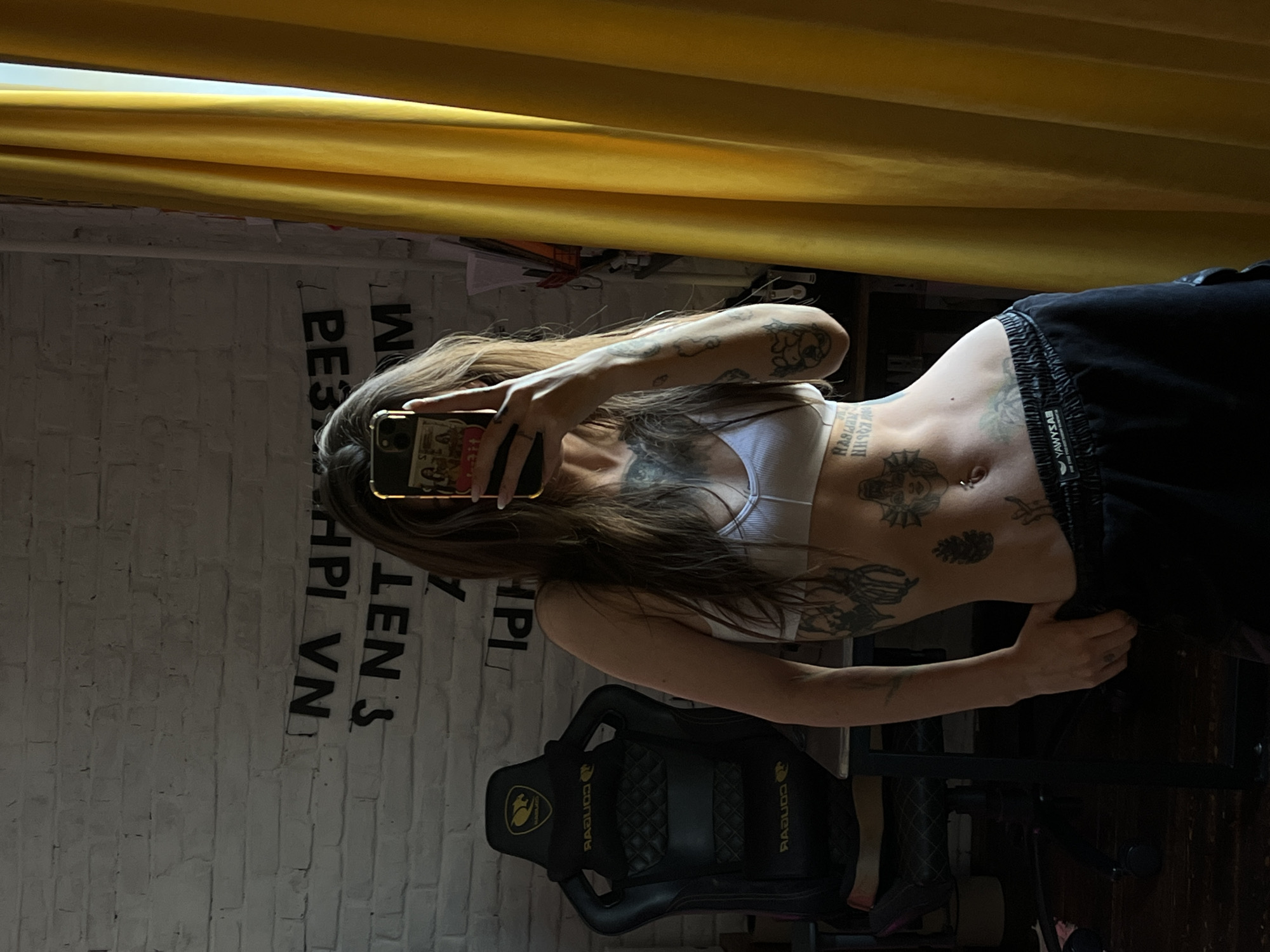 Tattooed individual takes mirror selfie in Krasnoyarsk