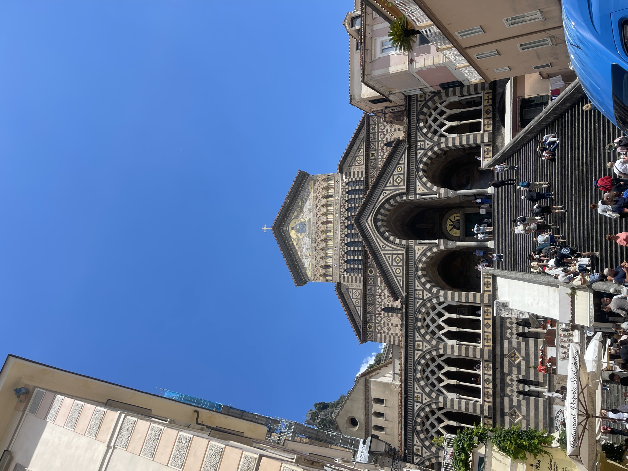 Tourists document Amalfi Cathedral and coastal views in Italy