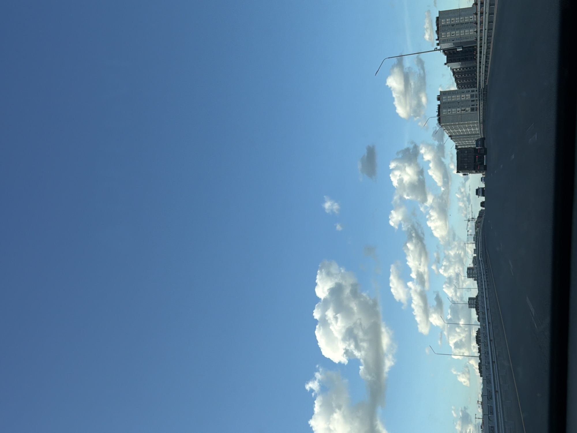 On the road through Astana, cranes and city skyline in view