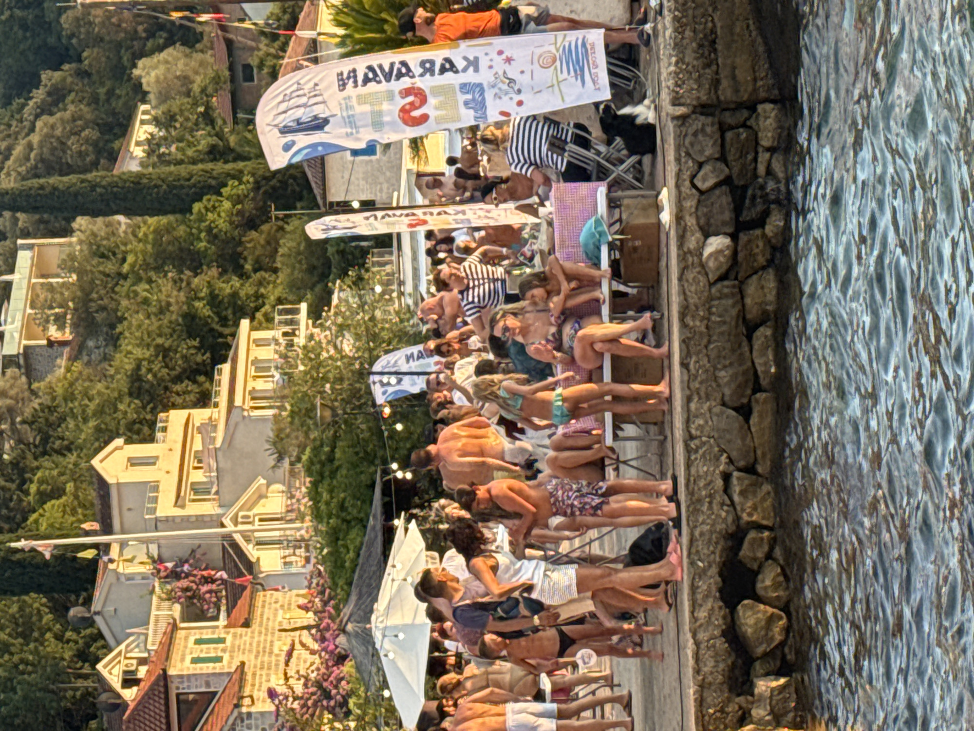 Sunny pier gathering with swimming, paddleboarding, and sunset views