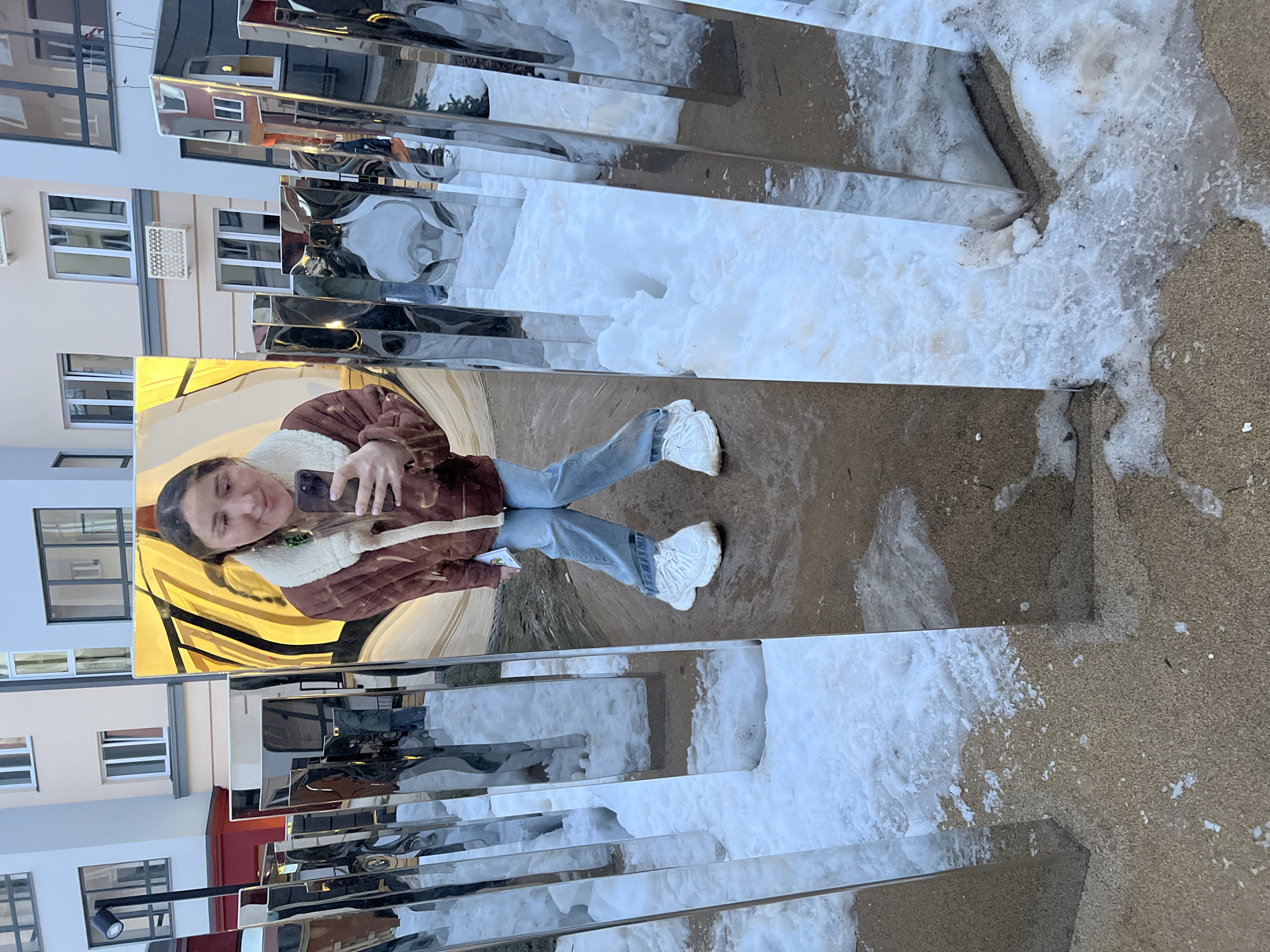 Woman takes selfies at mirrored art installation in Russia