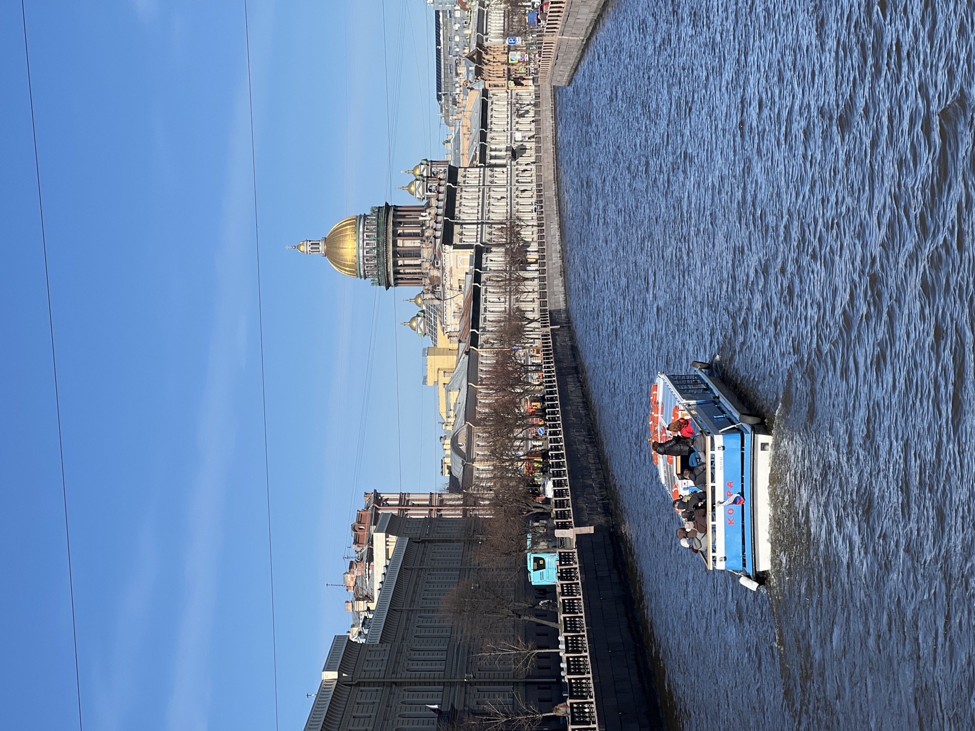 Tourist boat carries passengers past Saint Isaac's Cathedral in Petersburg