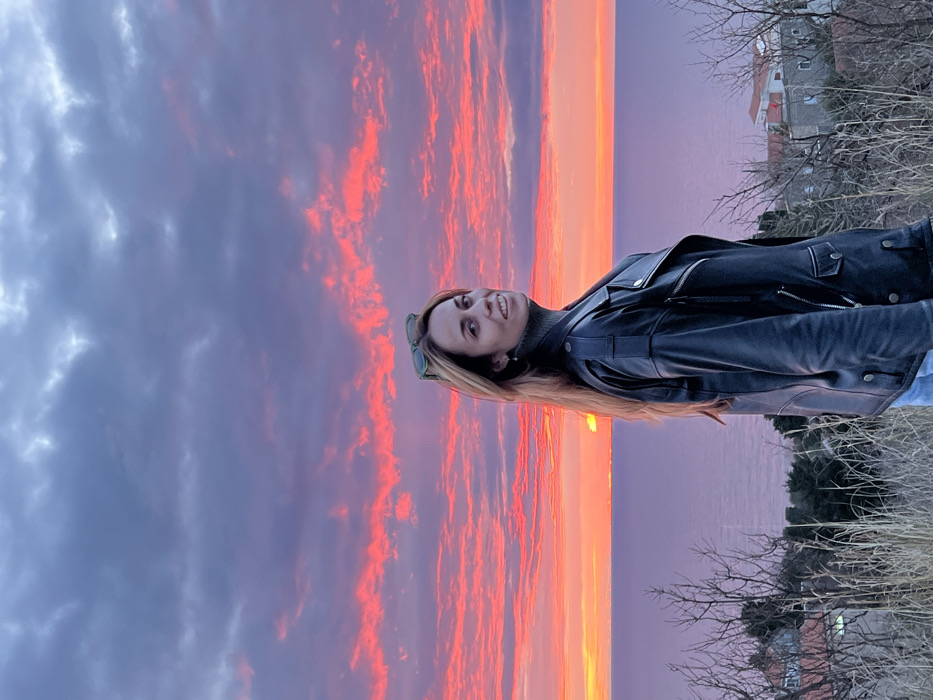 Woman photographs sunset selfies in Montenegro coastal area