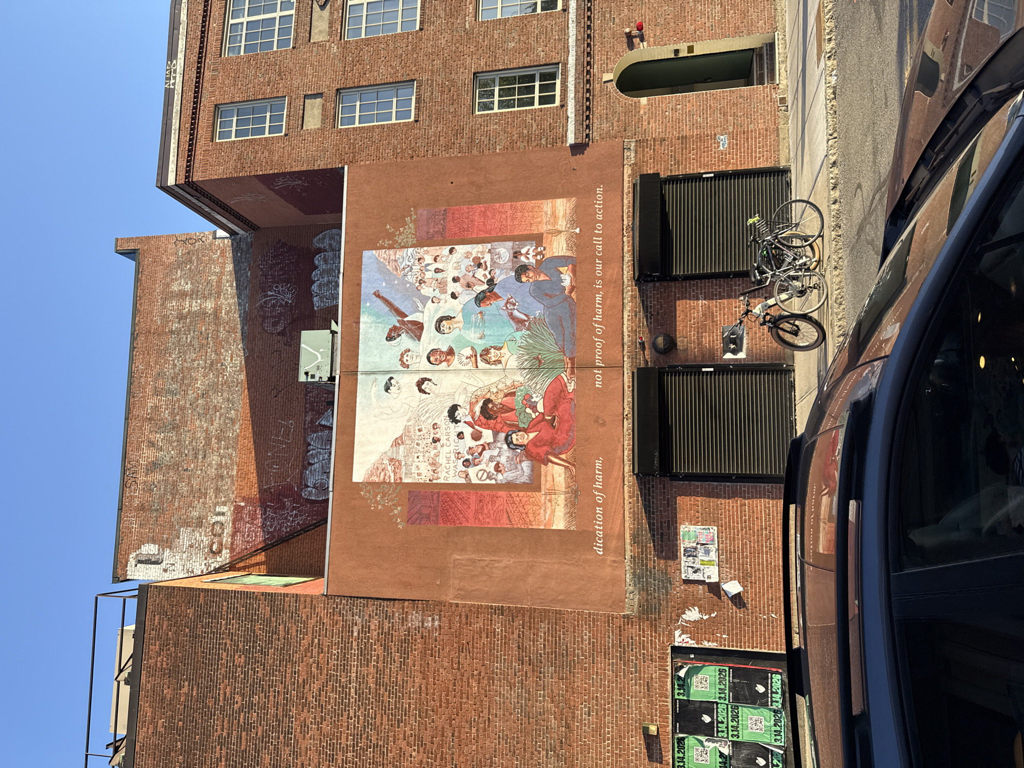 Multi-ethnic mural documented on Cambridge brick building