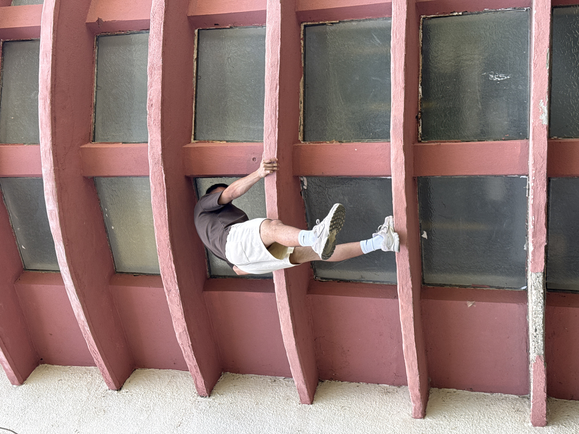 Free-climbing the exterior of a curved building in Shumen