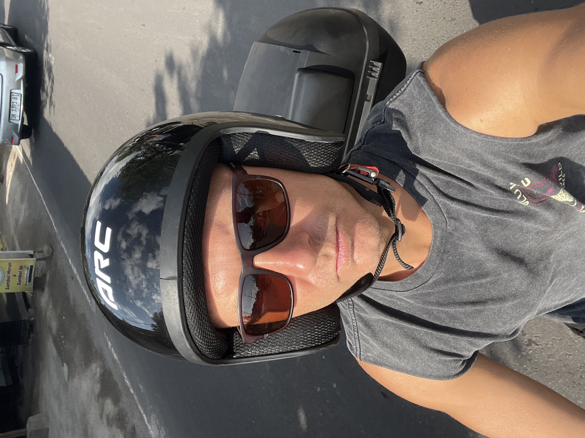 Scooter riding through busy Sukawati streets on a sunny Bali morning