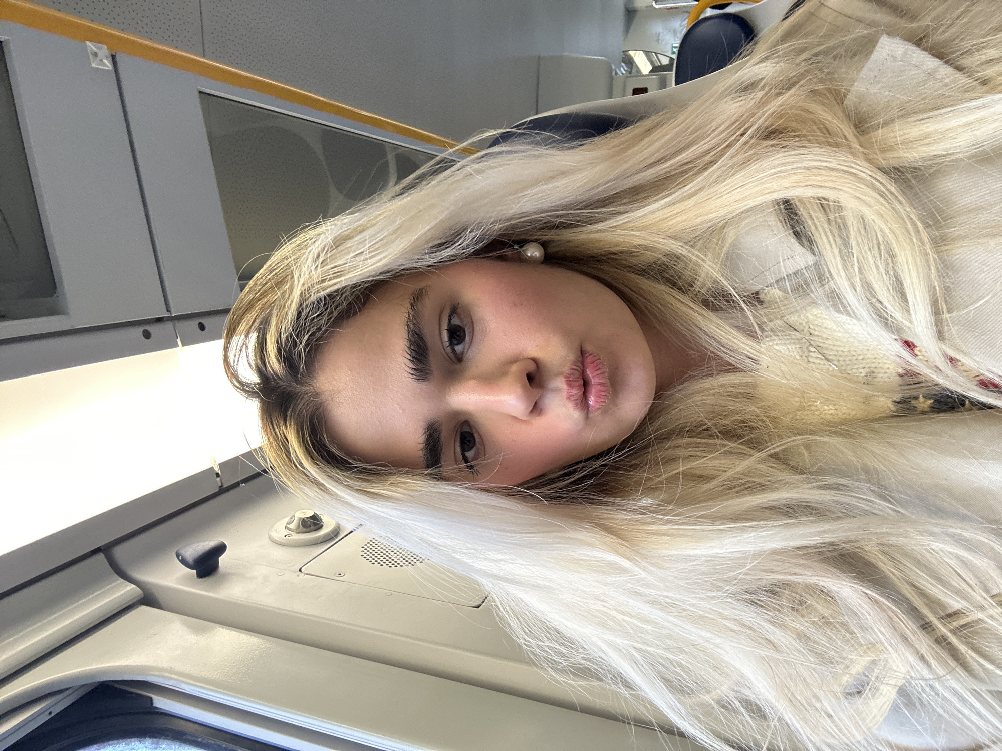 Woman takes selfie while traveling by train in Milan