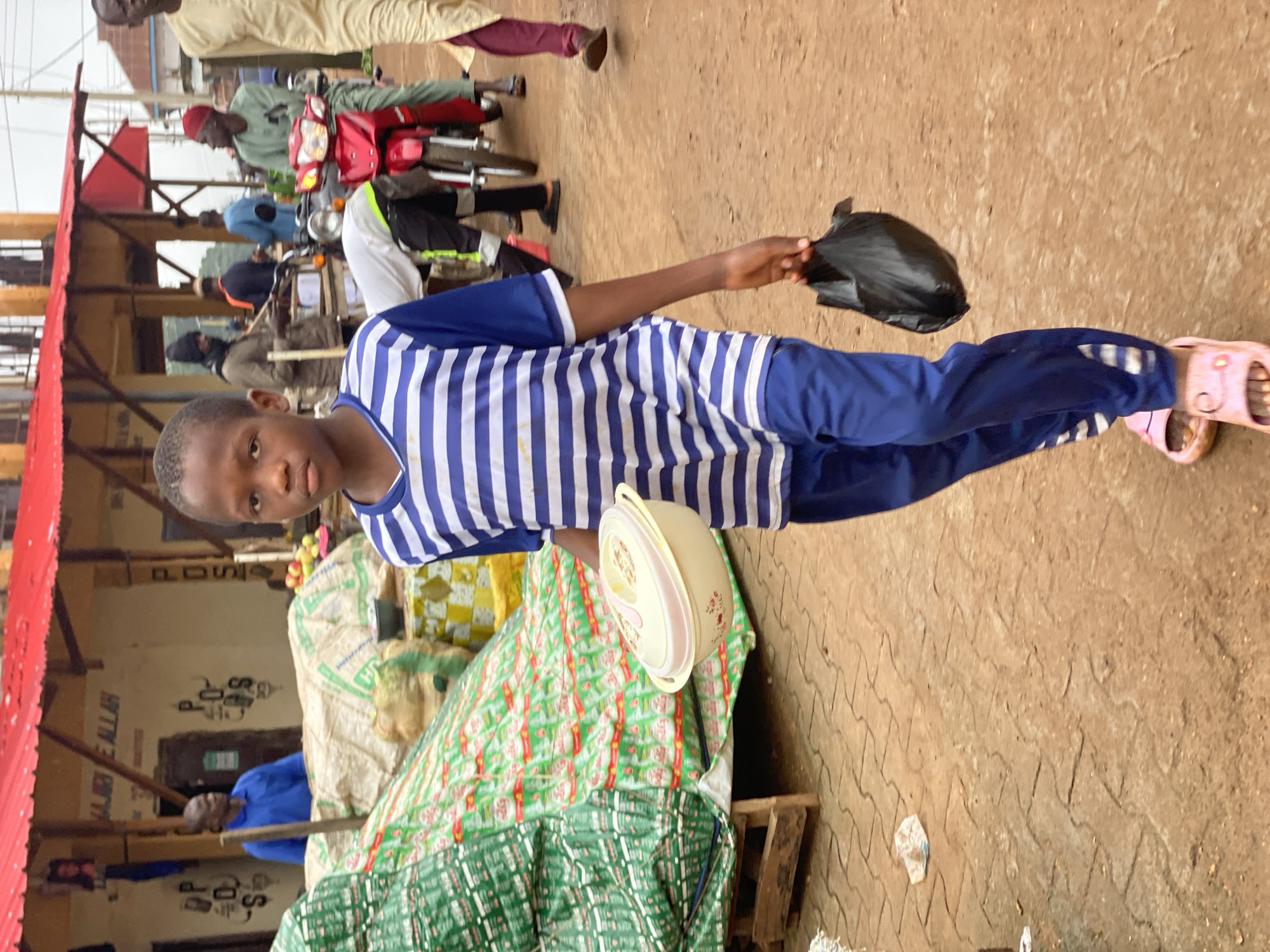Morning foot traffic through a street market in Kafanchan B