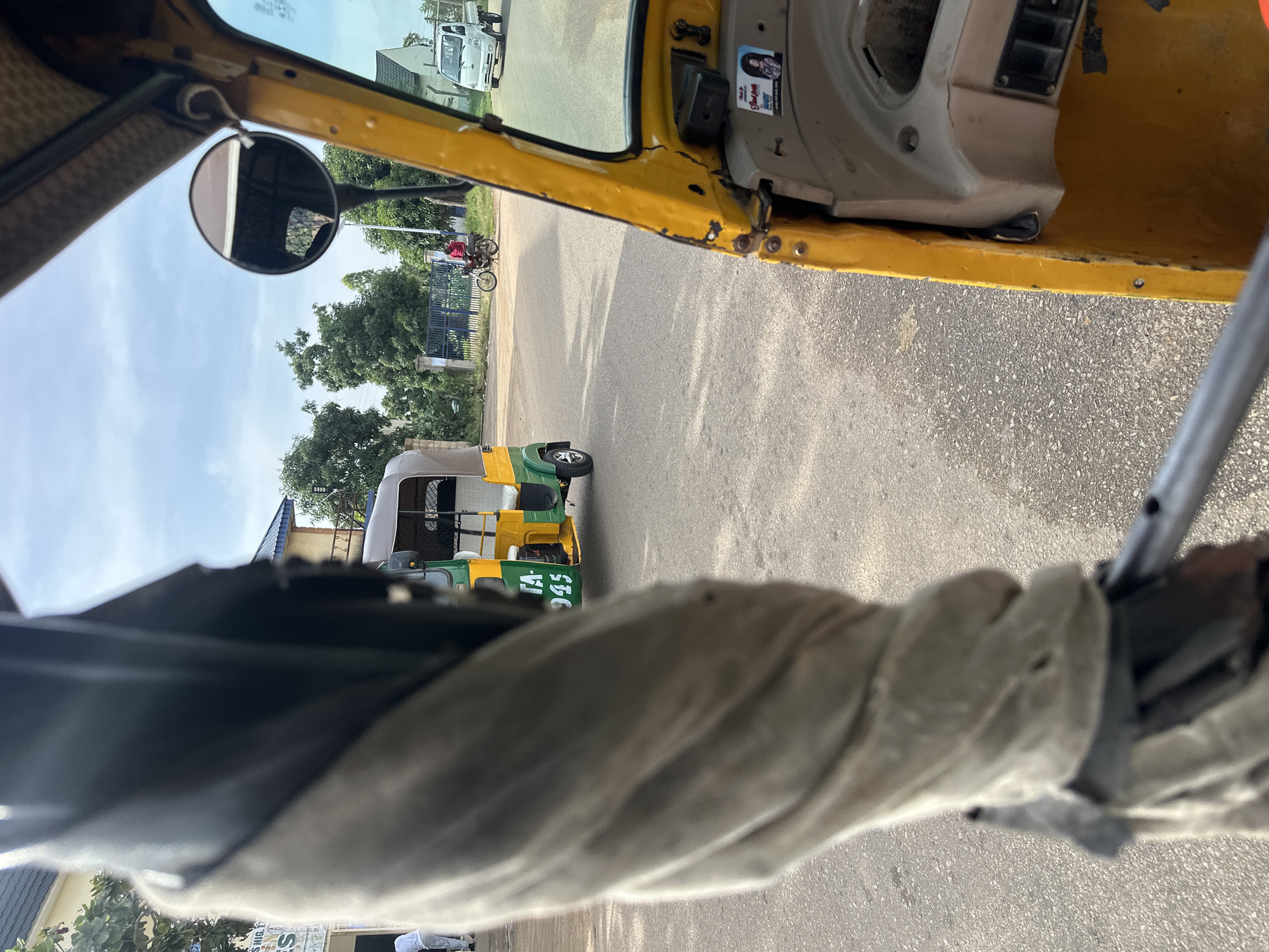 Inside a yellow auto-rickshaw rolling through Bukuru streets
