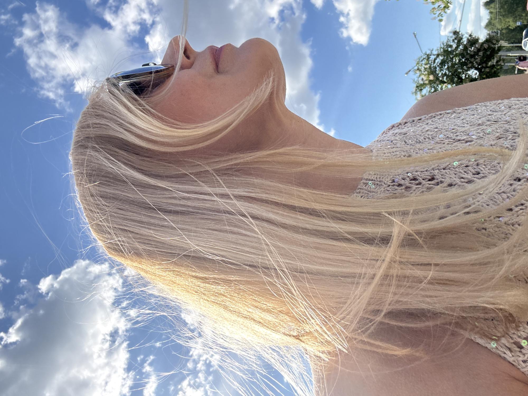 Woman gazes skyward during sunny afternoon in Minsk