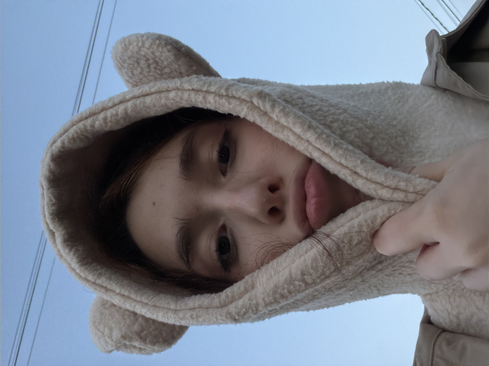 Bear-eared hoodie selfies mixed with quiet dusk street scenes