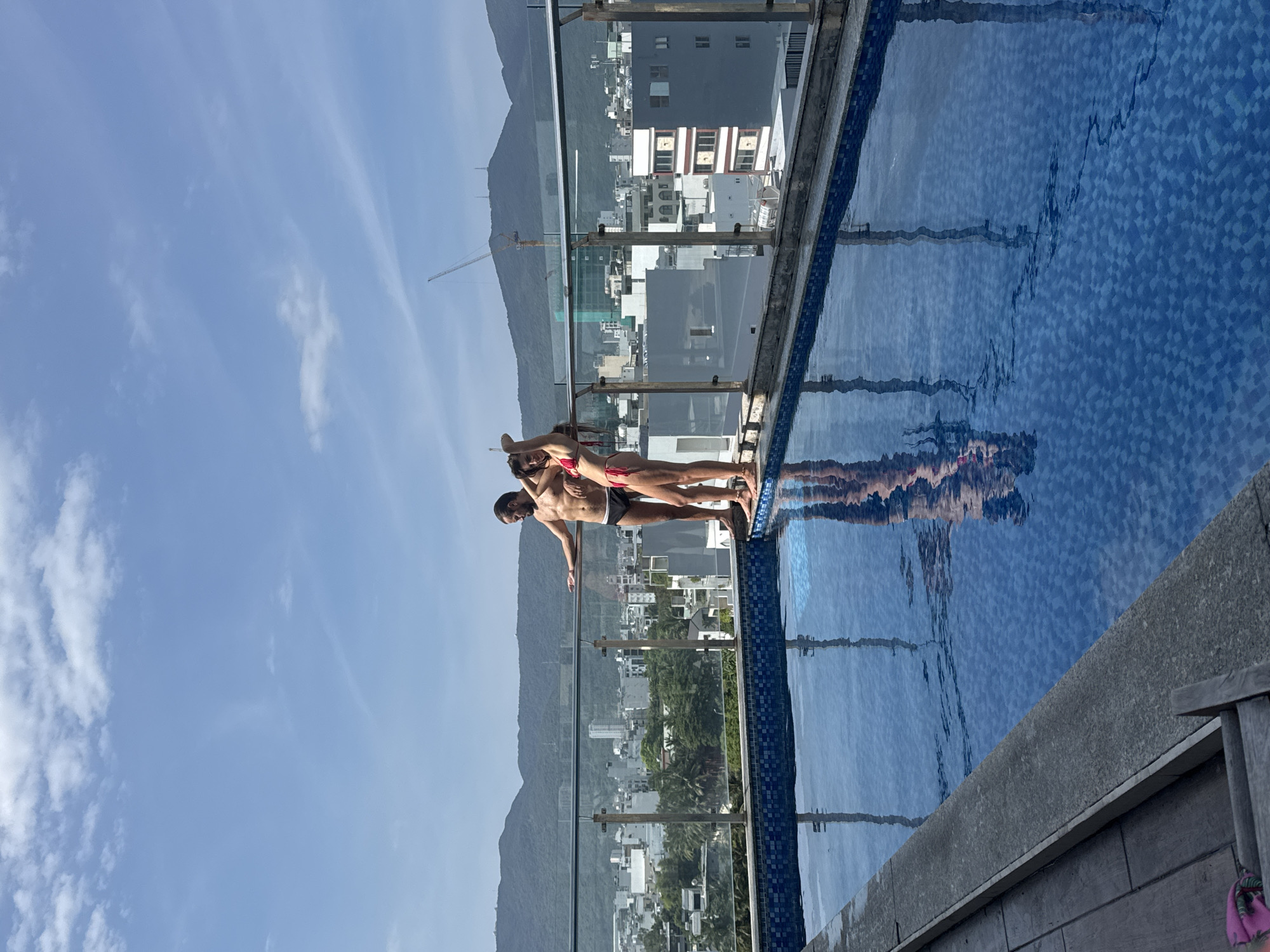 Swimmers pose at rooftop infinity pool overlooking Đà Nẵng