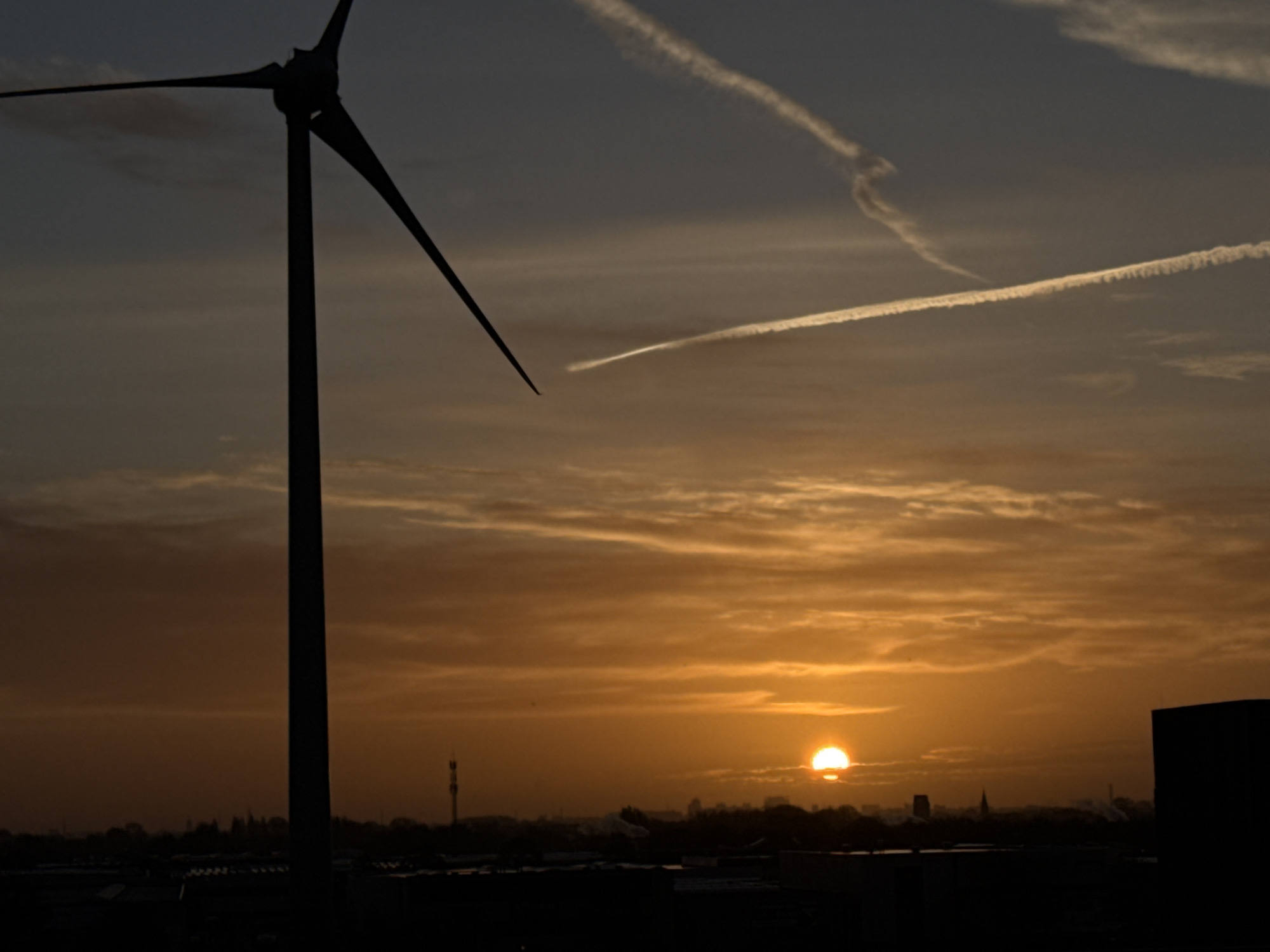 Sunset documented over Maasdijk windmills and cityscape