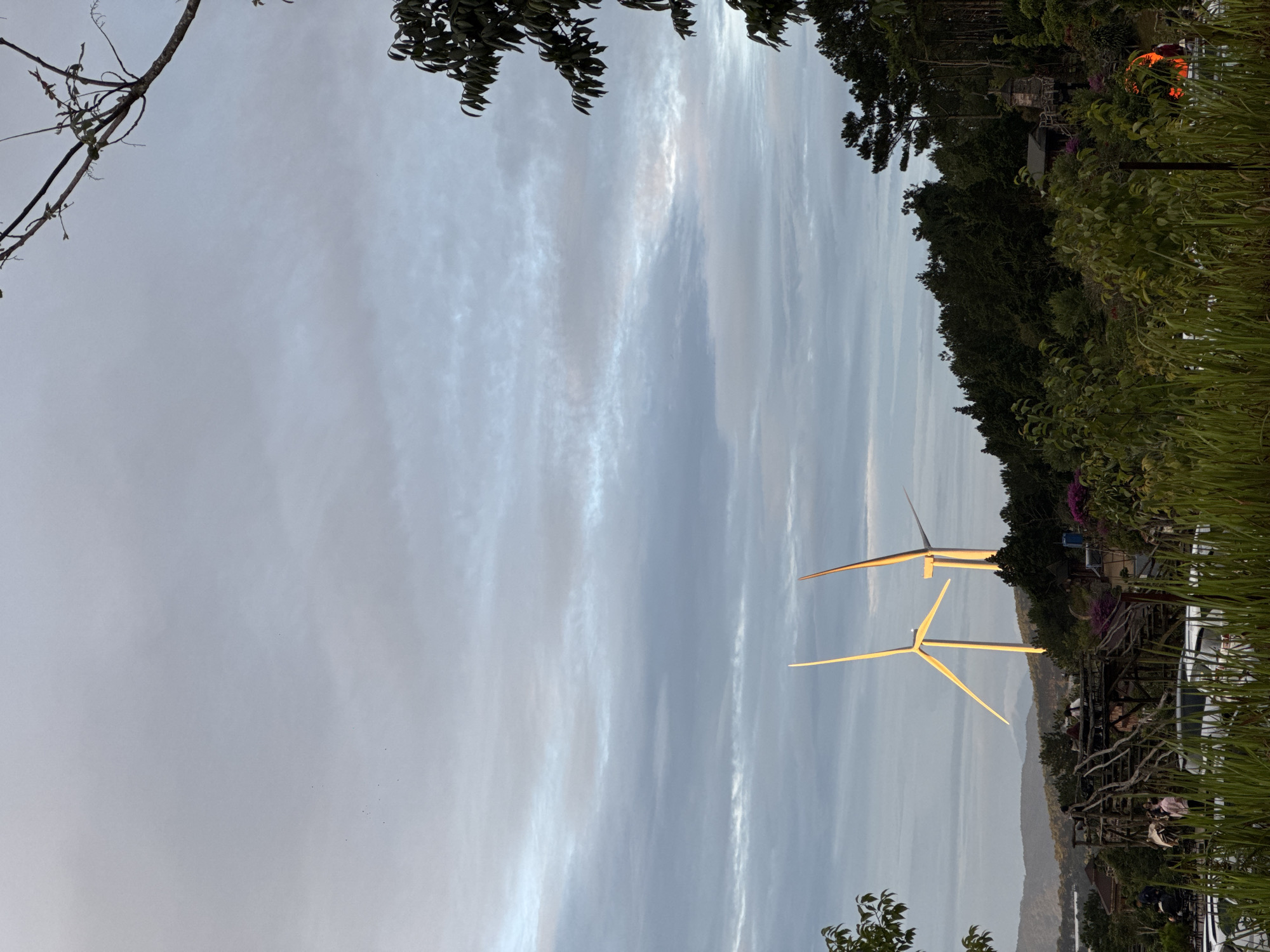 Wind turbines operational near Phát Chi, Vietnam at dusk