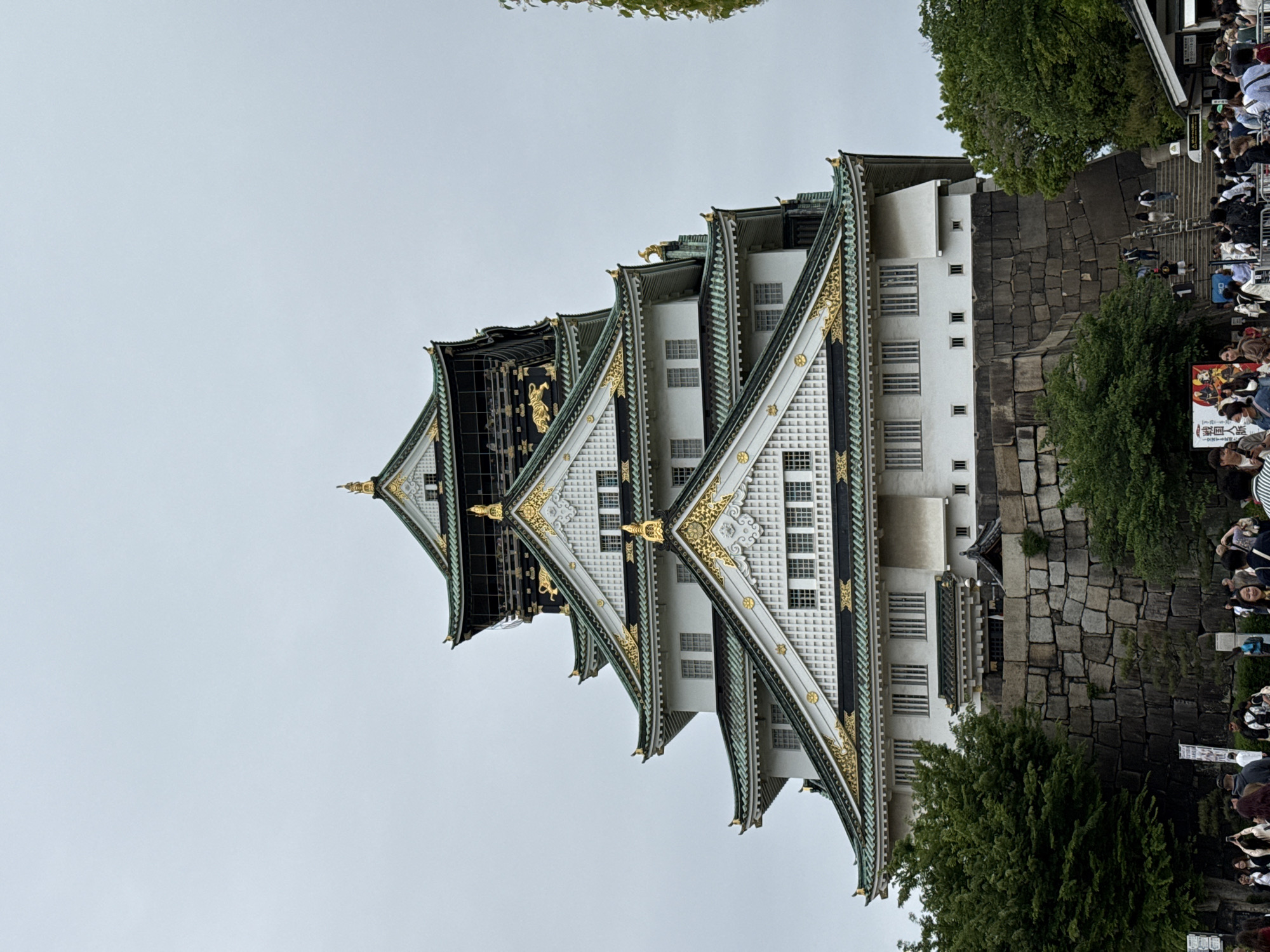Visitor documents Osaka Castle and park grounds during morning visit