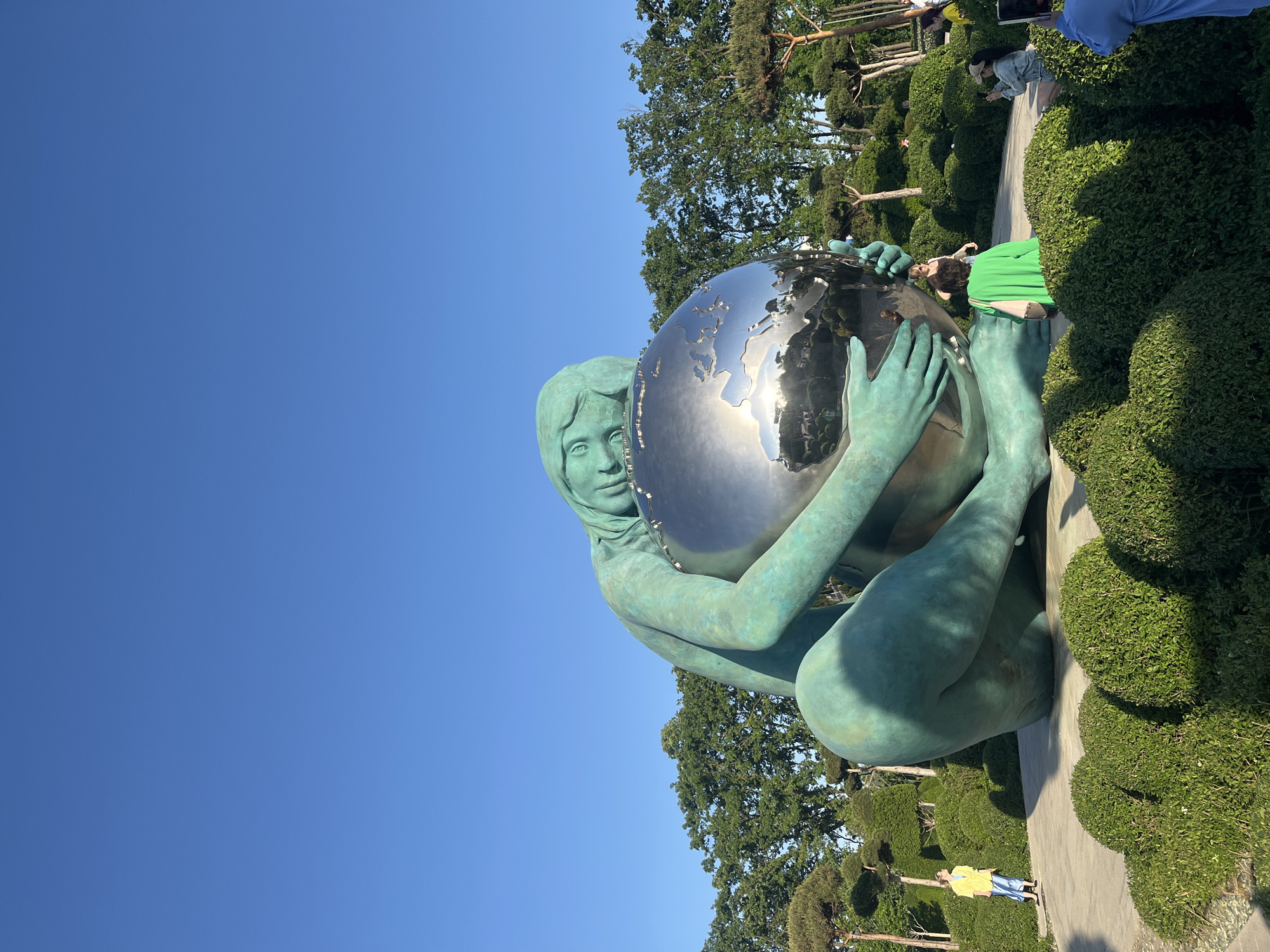 Park visitors observe Girl Holding World sculpture in Krasnodar