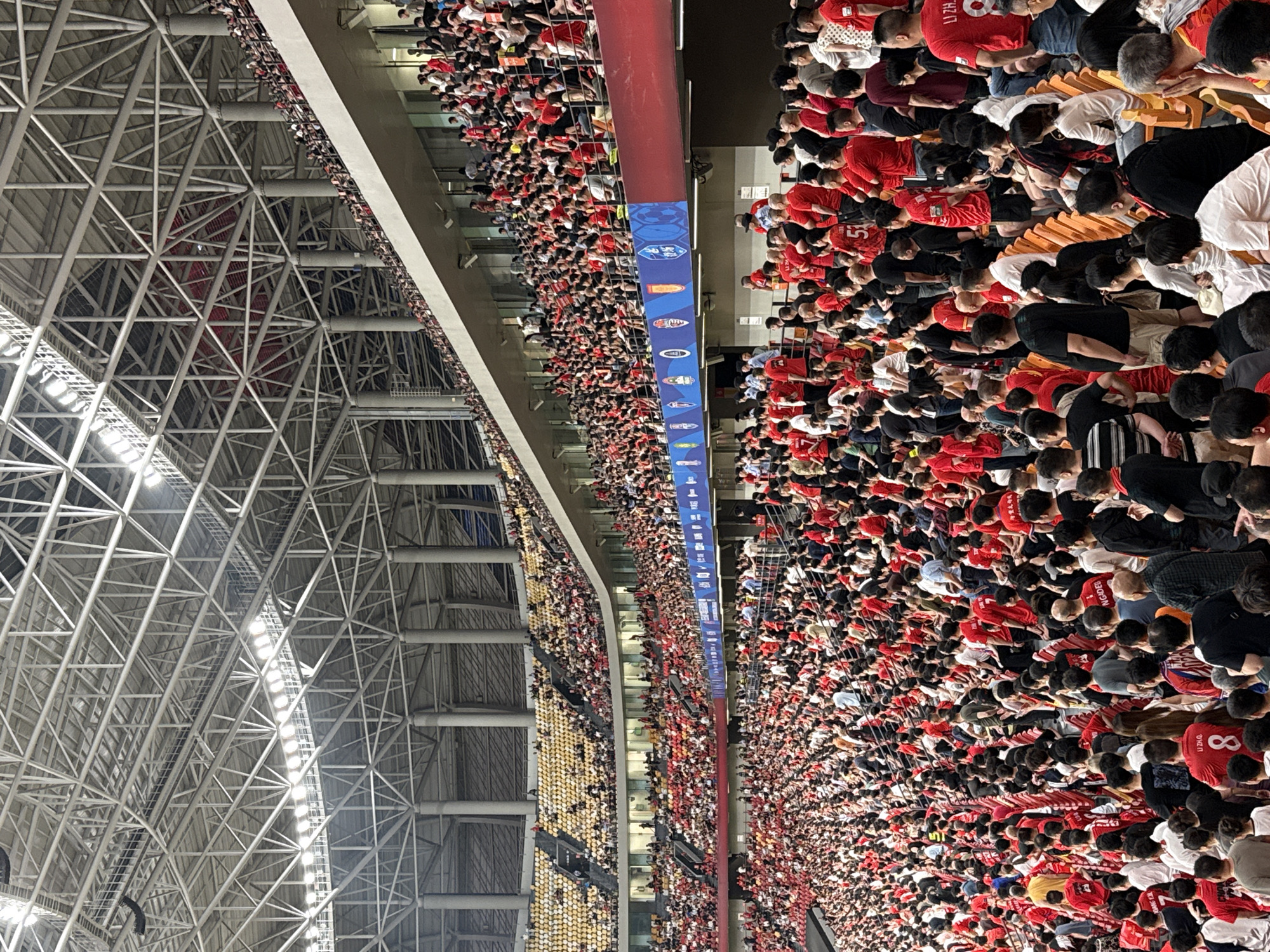 Red-shirted crowd fills indoor stadium in Longxing, China