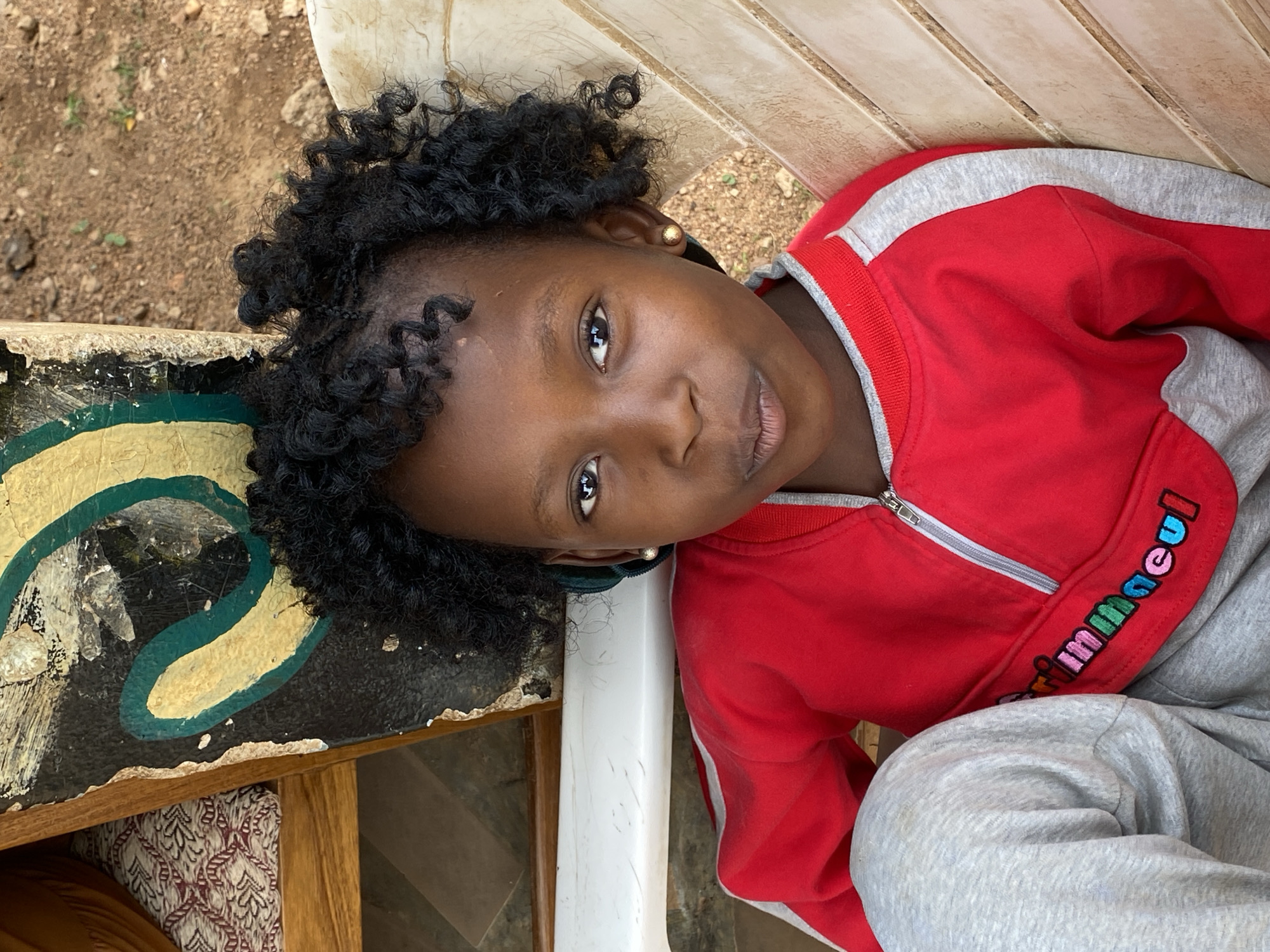 Child in tracksuit photographed outdoors in Kuru Karama, Nigeria