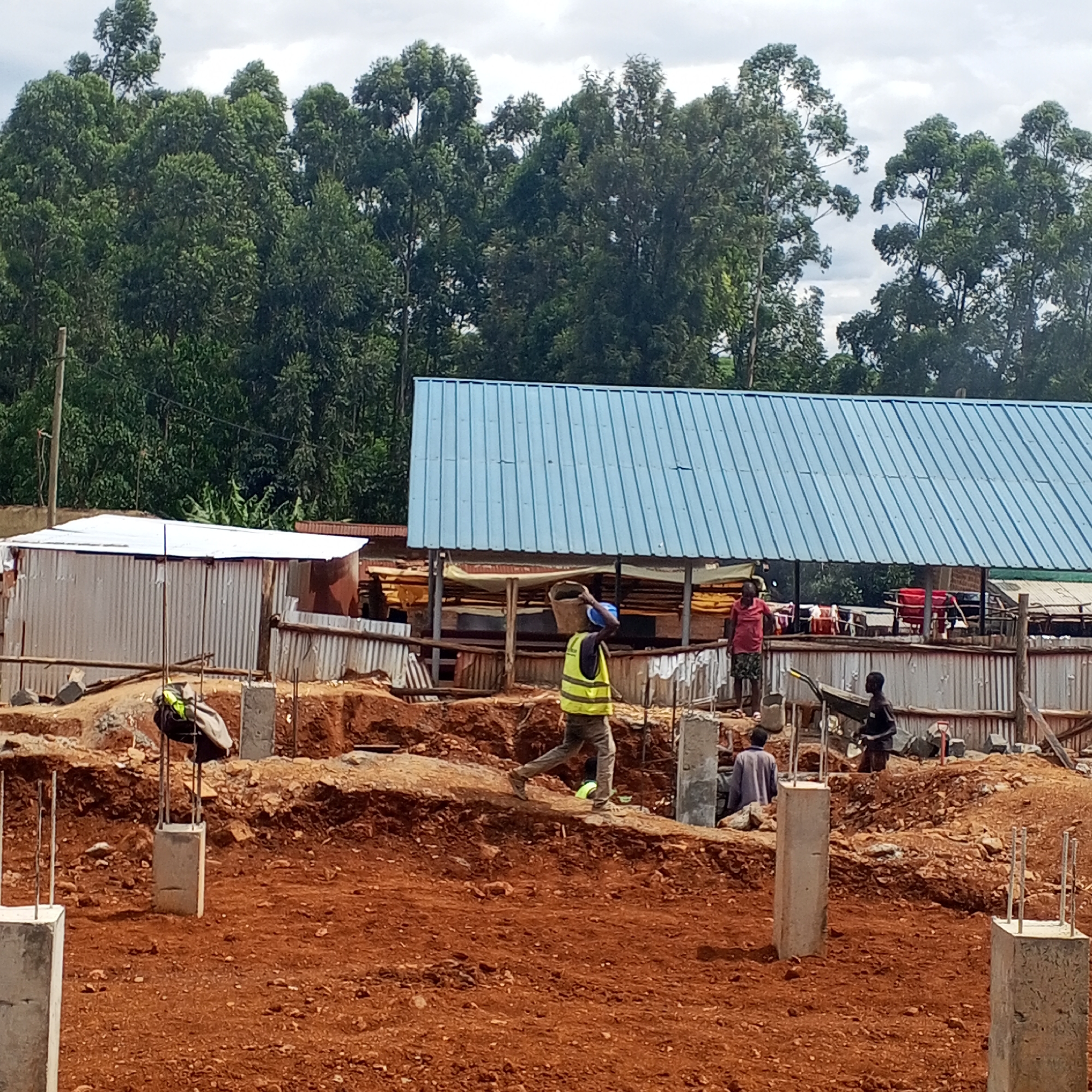 Construction site with concrete posts observed in urban area