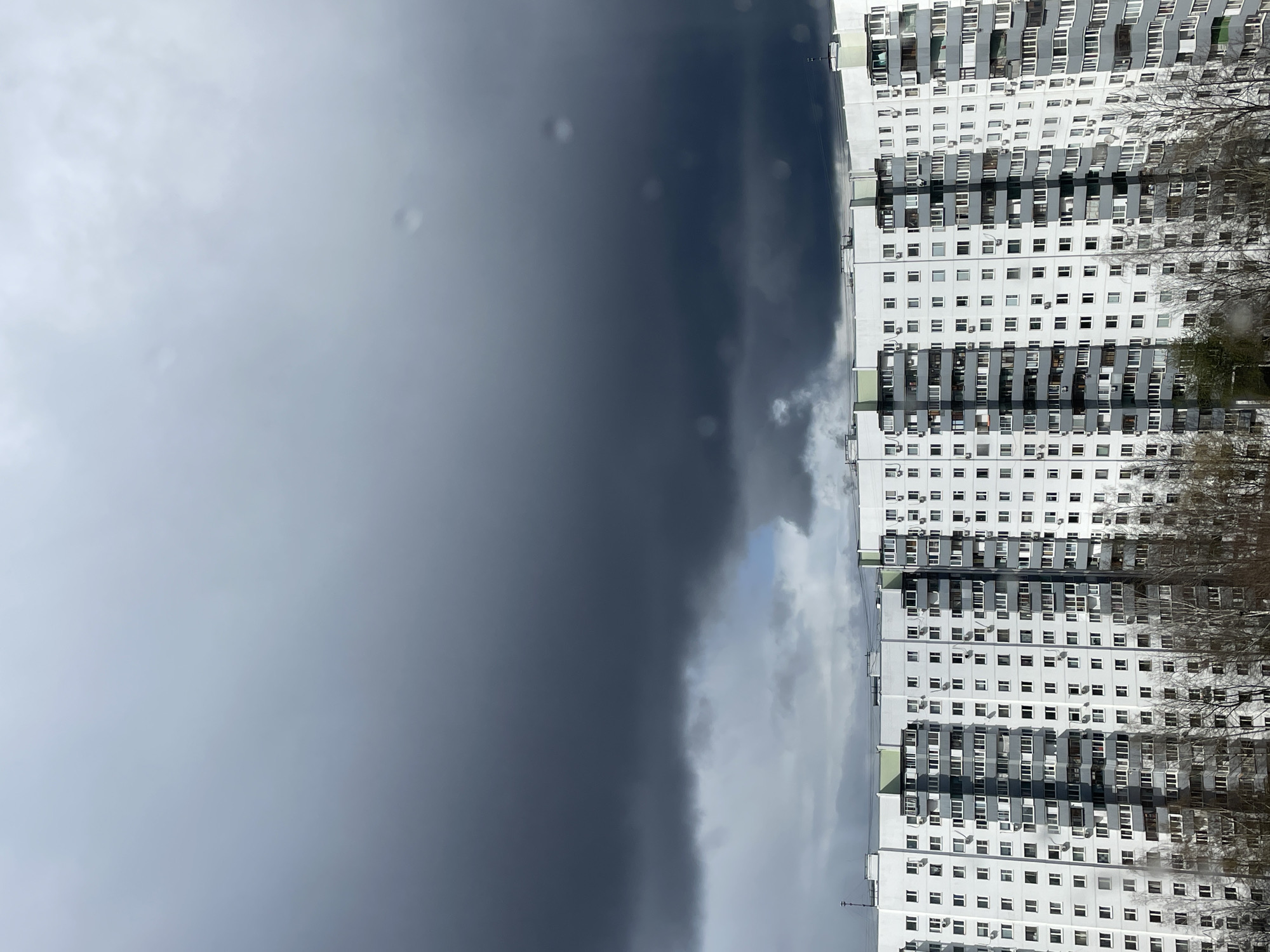 Moscow resident documents stormy morning, apartment building and shelf