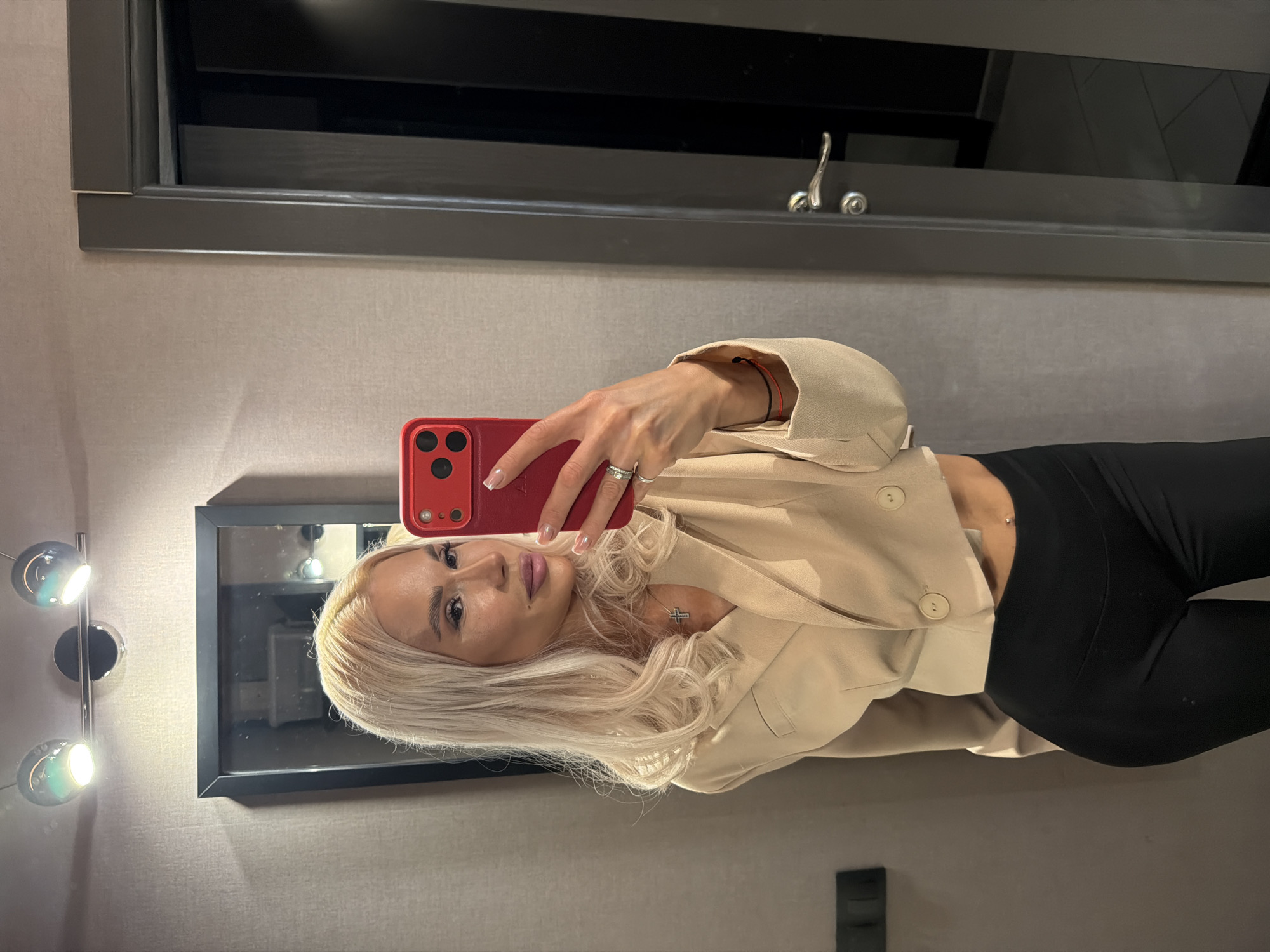 Mirror selfie in Kazan, styled in beige blazer and black.
