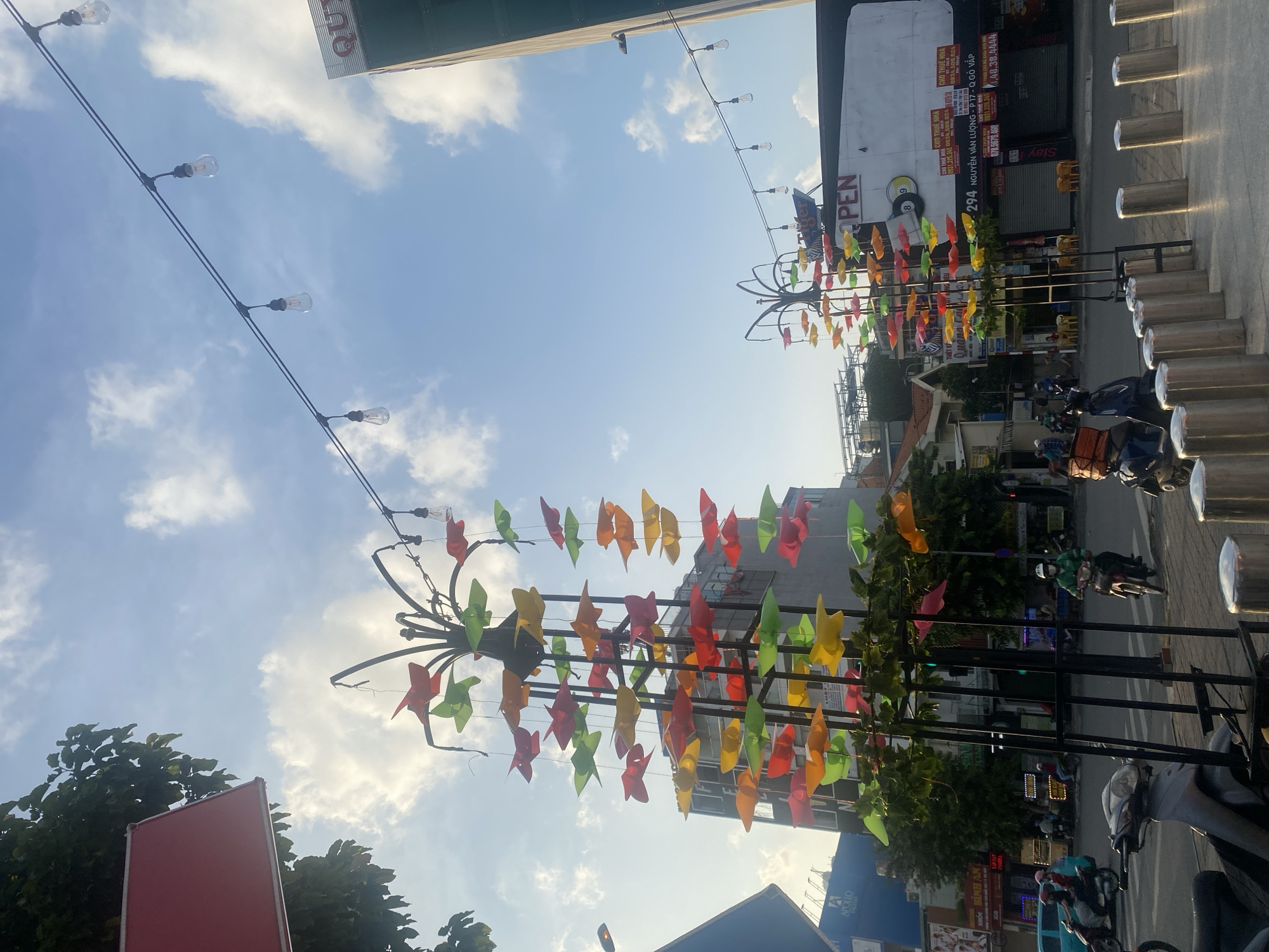 Decorated street in Thuận An with paper ornaments and light traffic