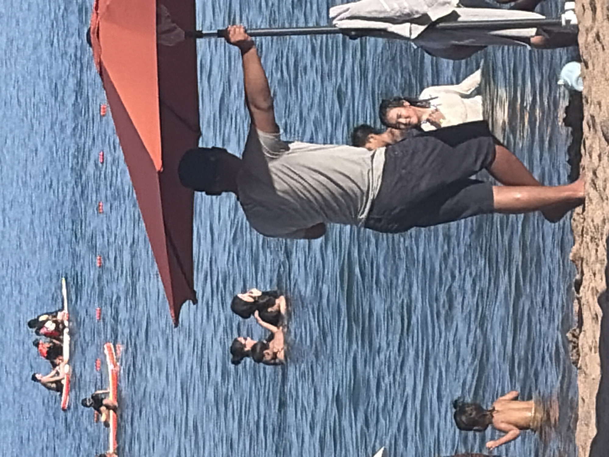 Paddleboarding, swimming, and beach relaxing on a sunny day