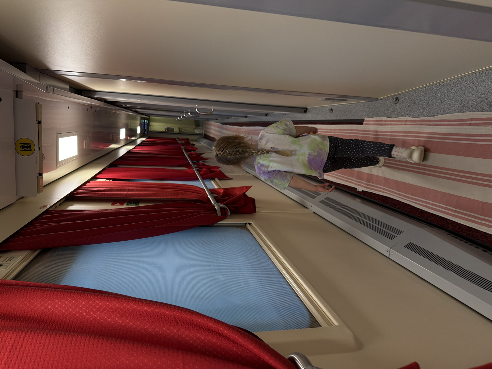 Train couchette car interior documented with young passenger present