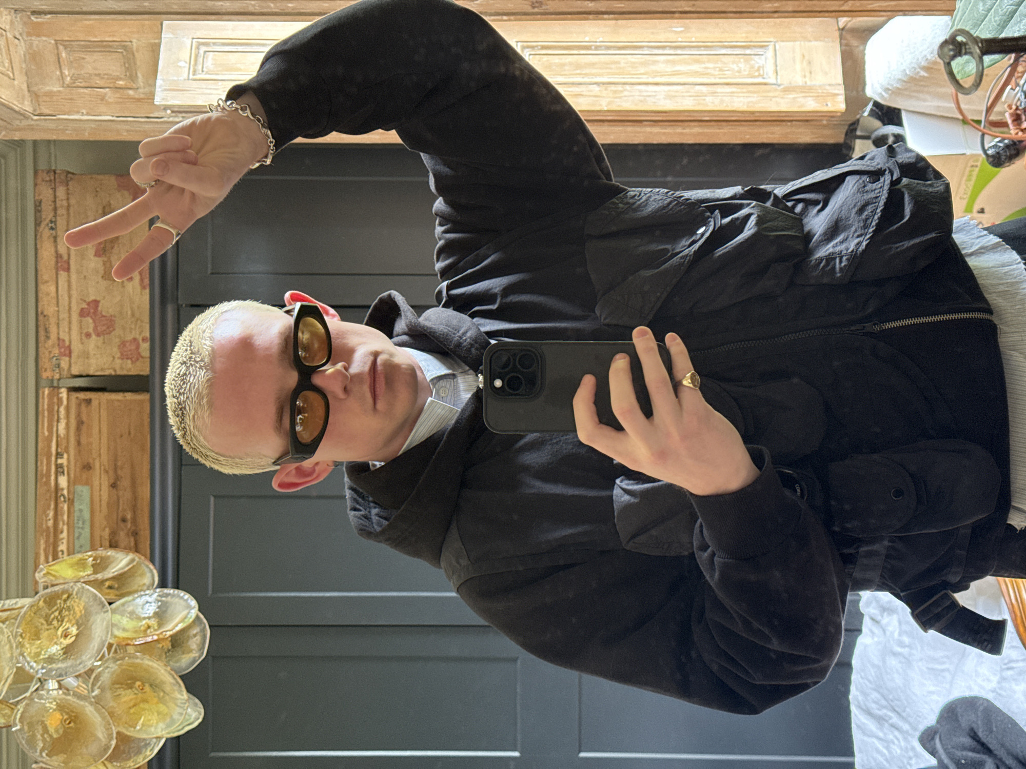 Blonde-haired person takes mirror selfie in London