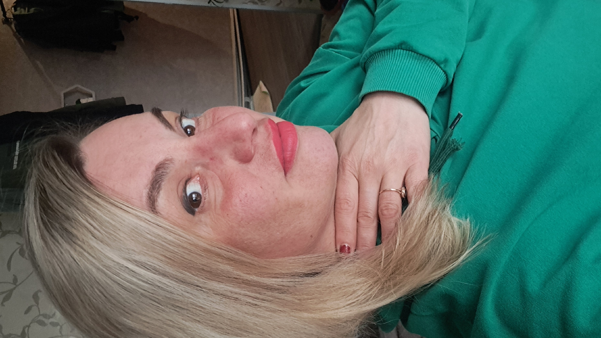 Woman in green hoodie photographed indoors in Elektrostal