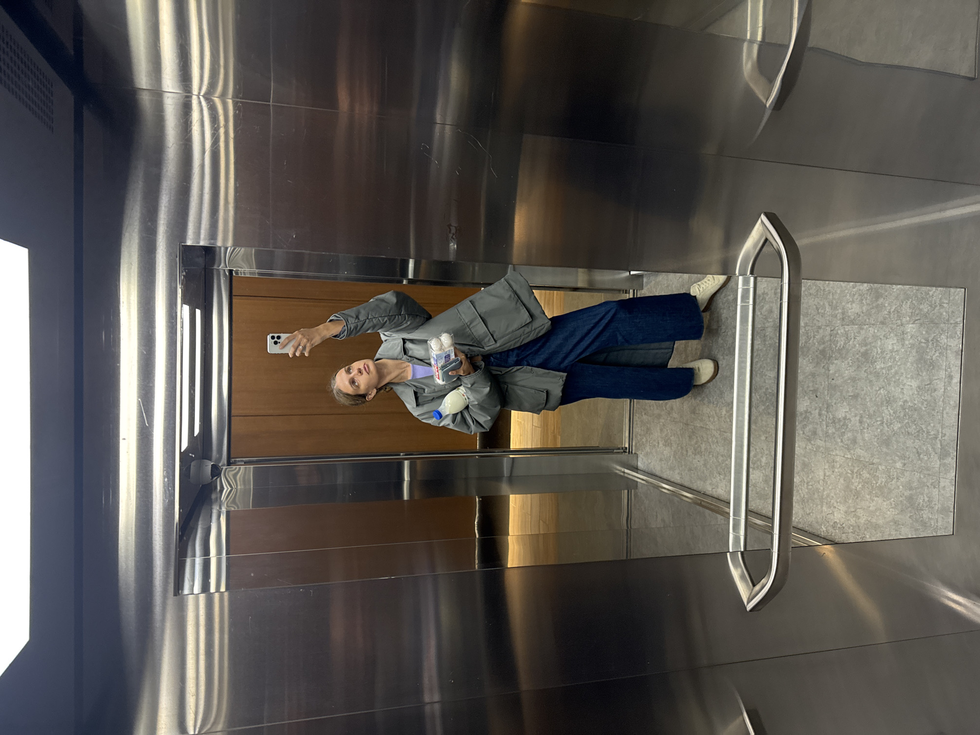 Woman Takes Multiple Selfies During Morning Elevator Ride